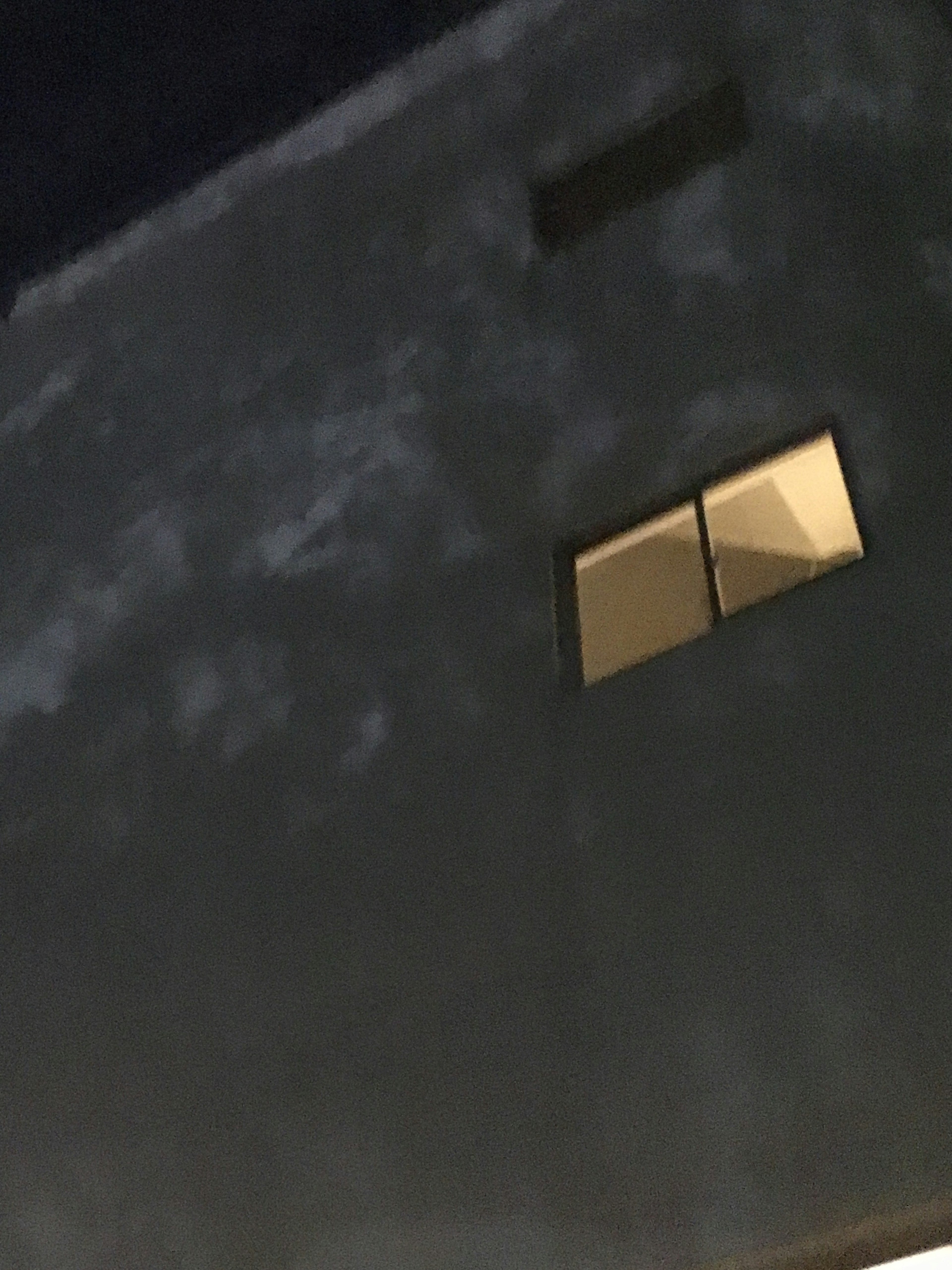 Night scene with a bright window on a dark wall