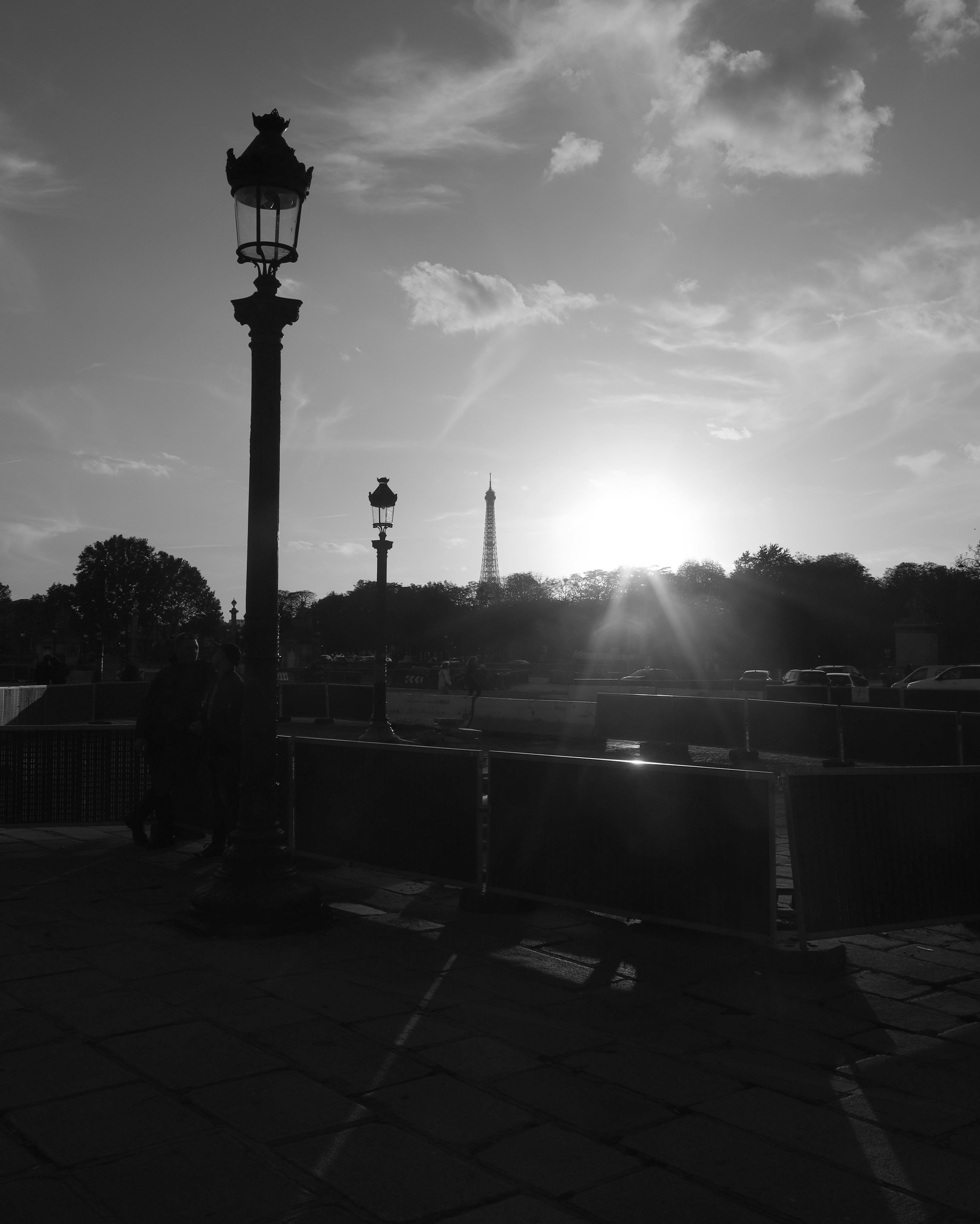 Silhouette of the Eiffel Tower at sunset with street lamp in Paris