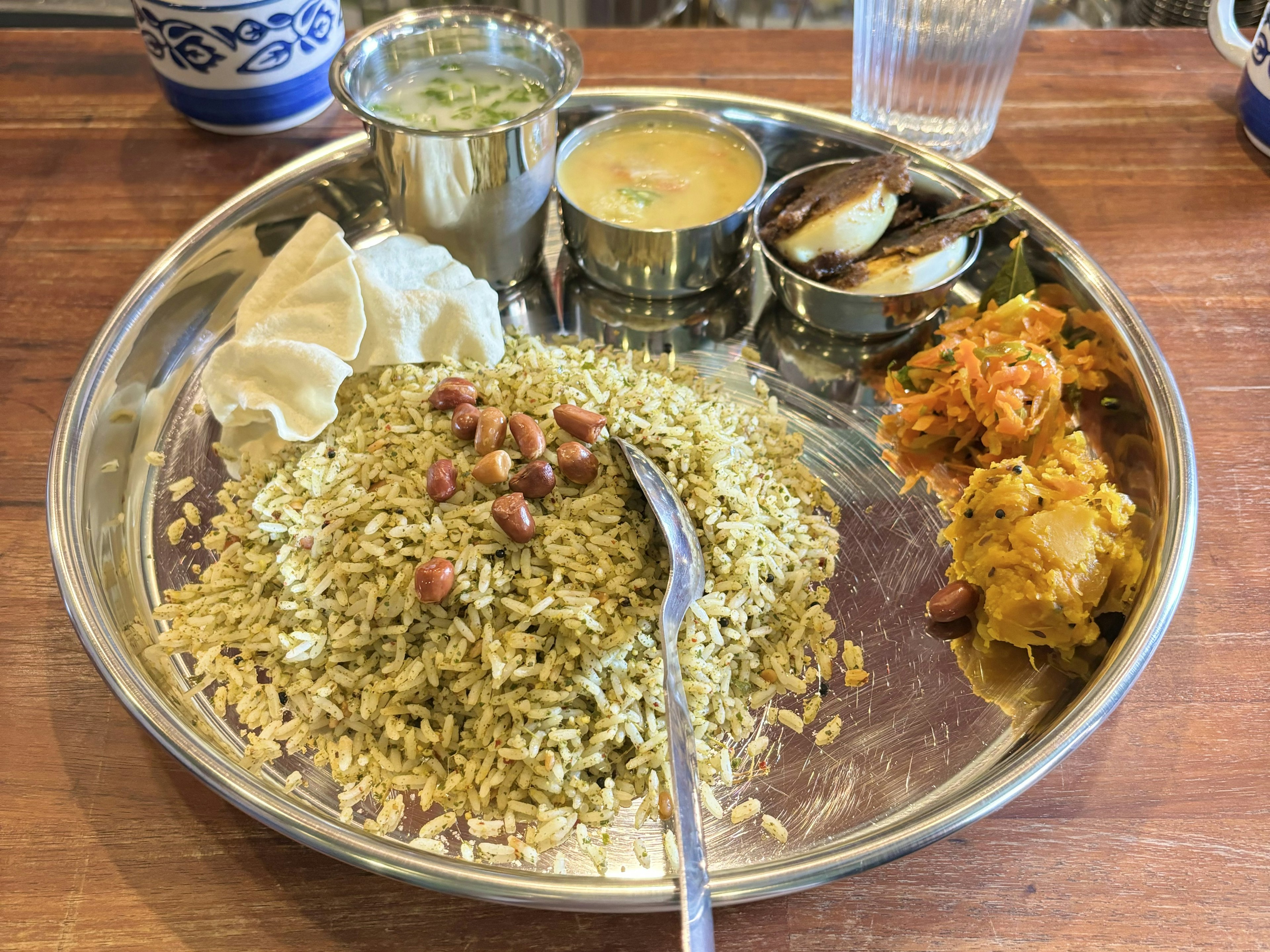 Basmati rice served on a silver platter with various side dishes