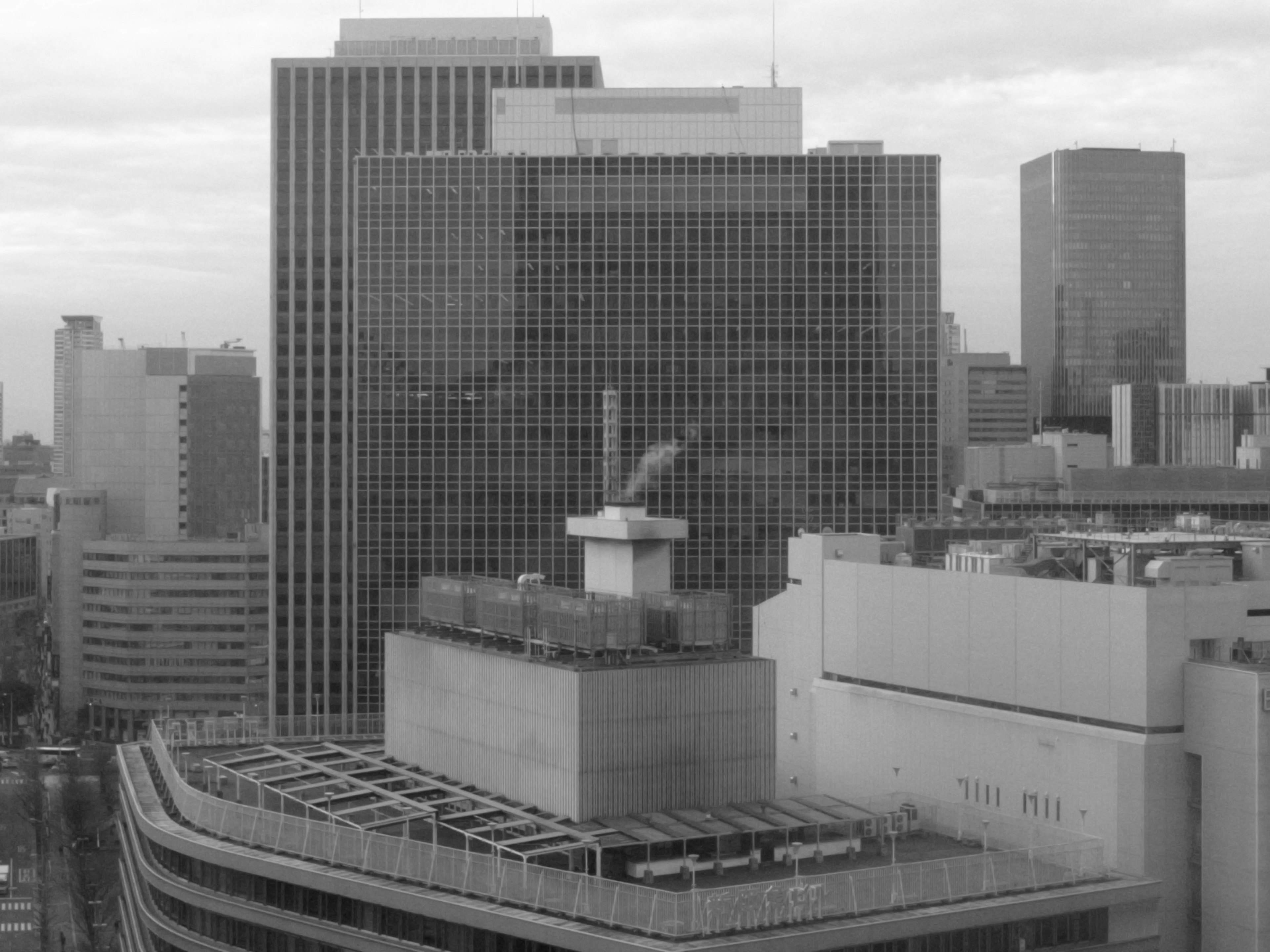 Urban skyline featuring high-rise buildings and rooftop chimney