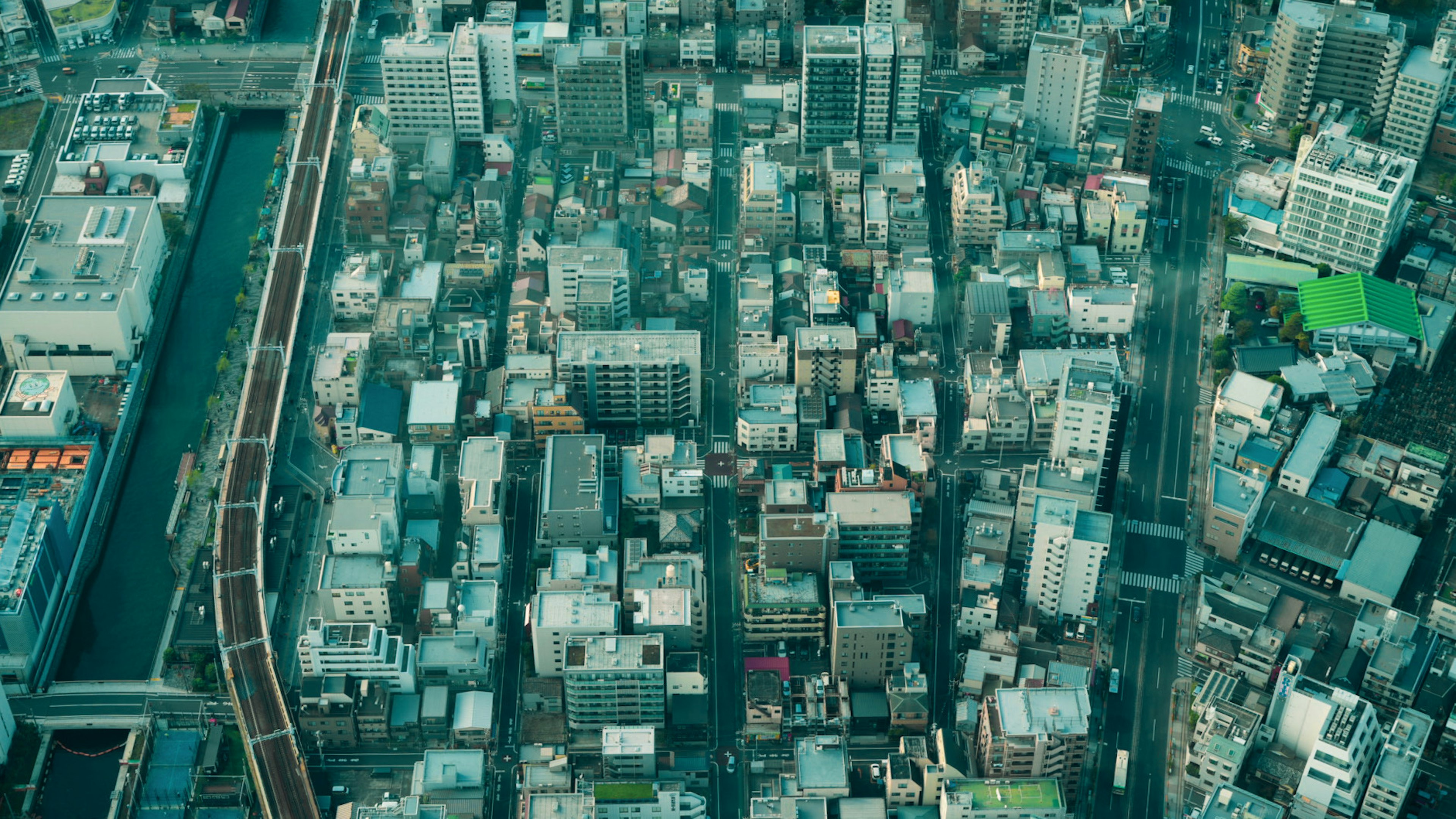 Aerial view of a city featuring a mix of skyscrapers and smaller buildings