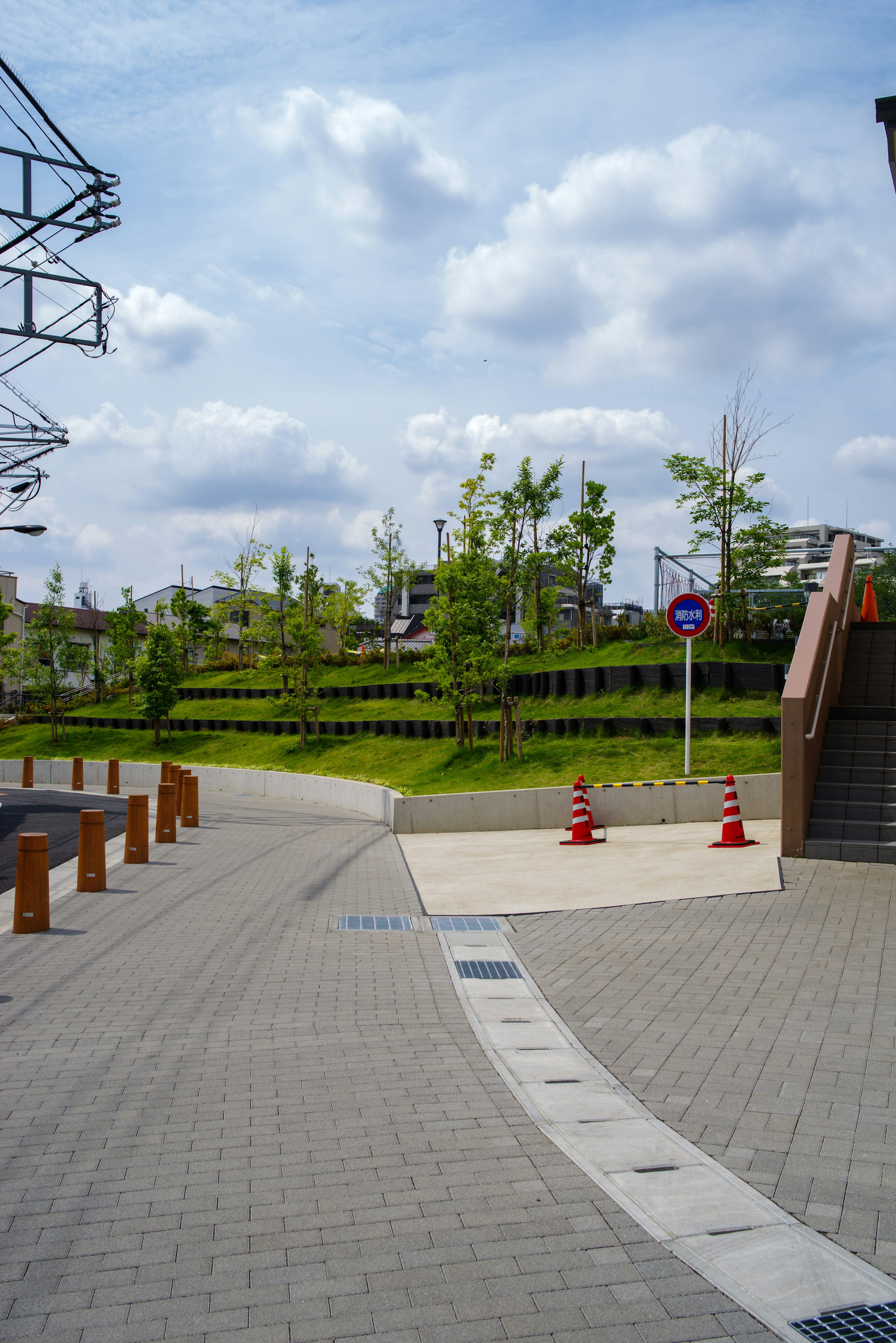 Pathway leading to a green park under a blue sky