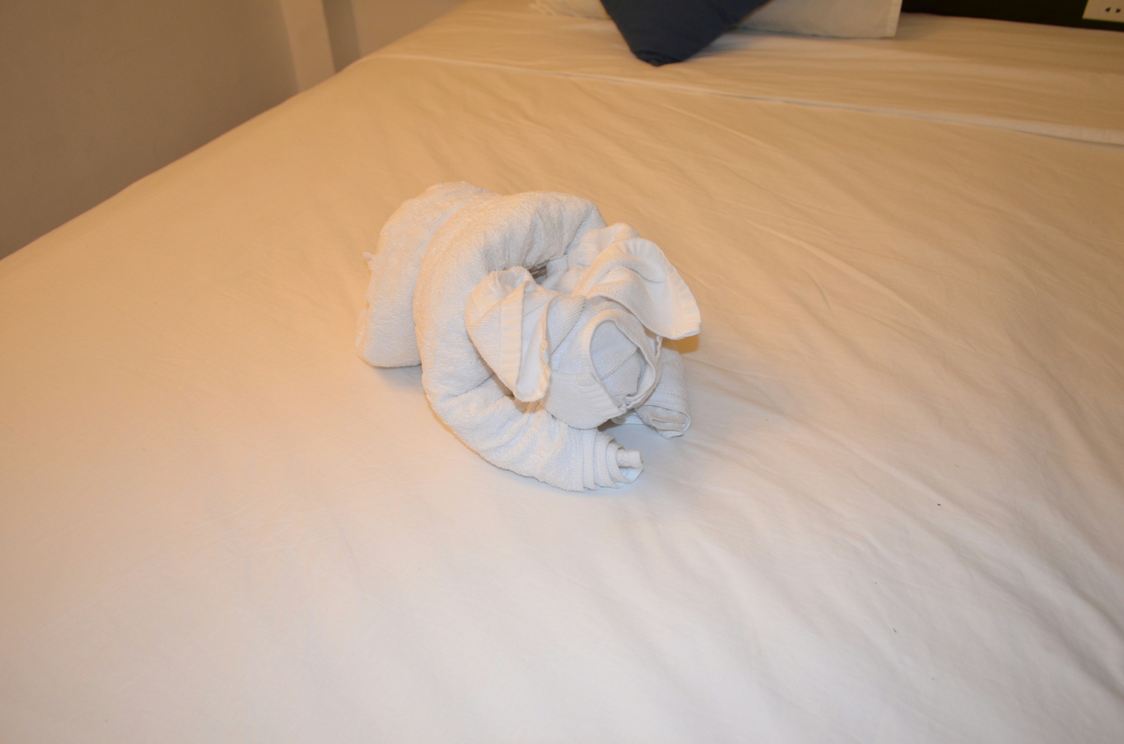 A towel shaped like a rabbit on a bed