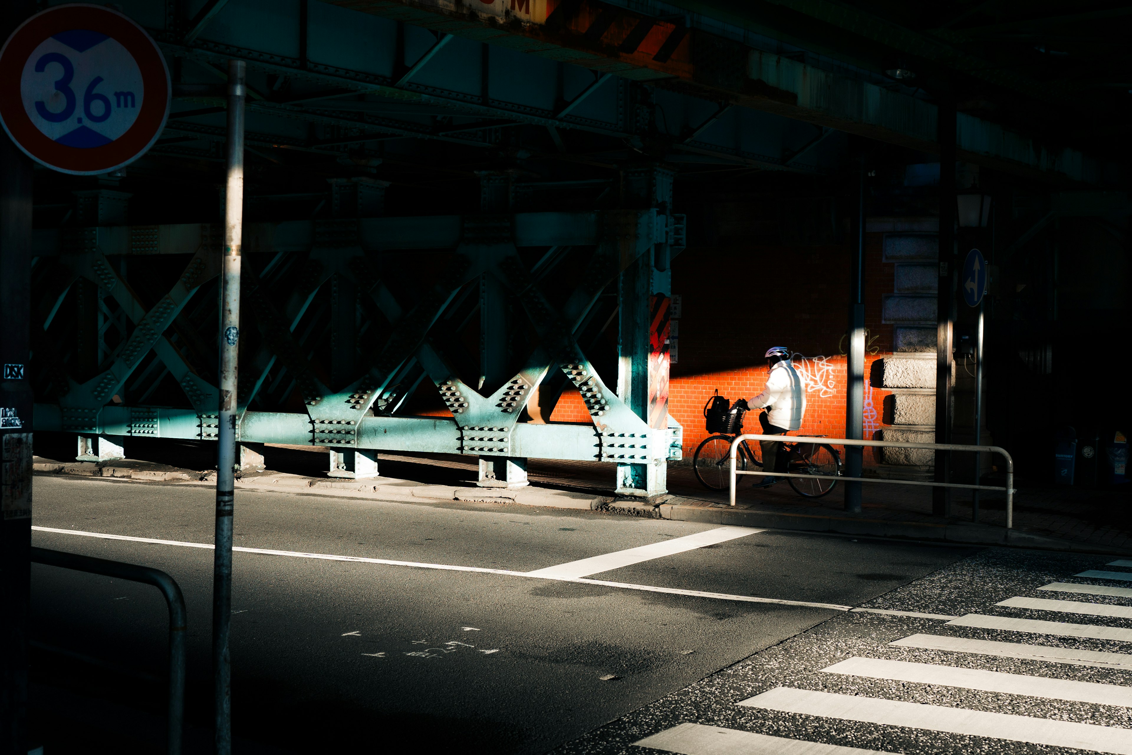 Intersection with a bridge structure in a dimly lit urban area