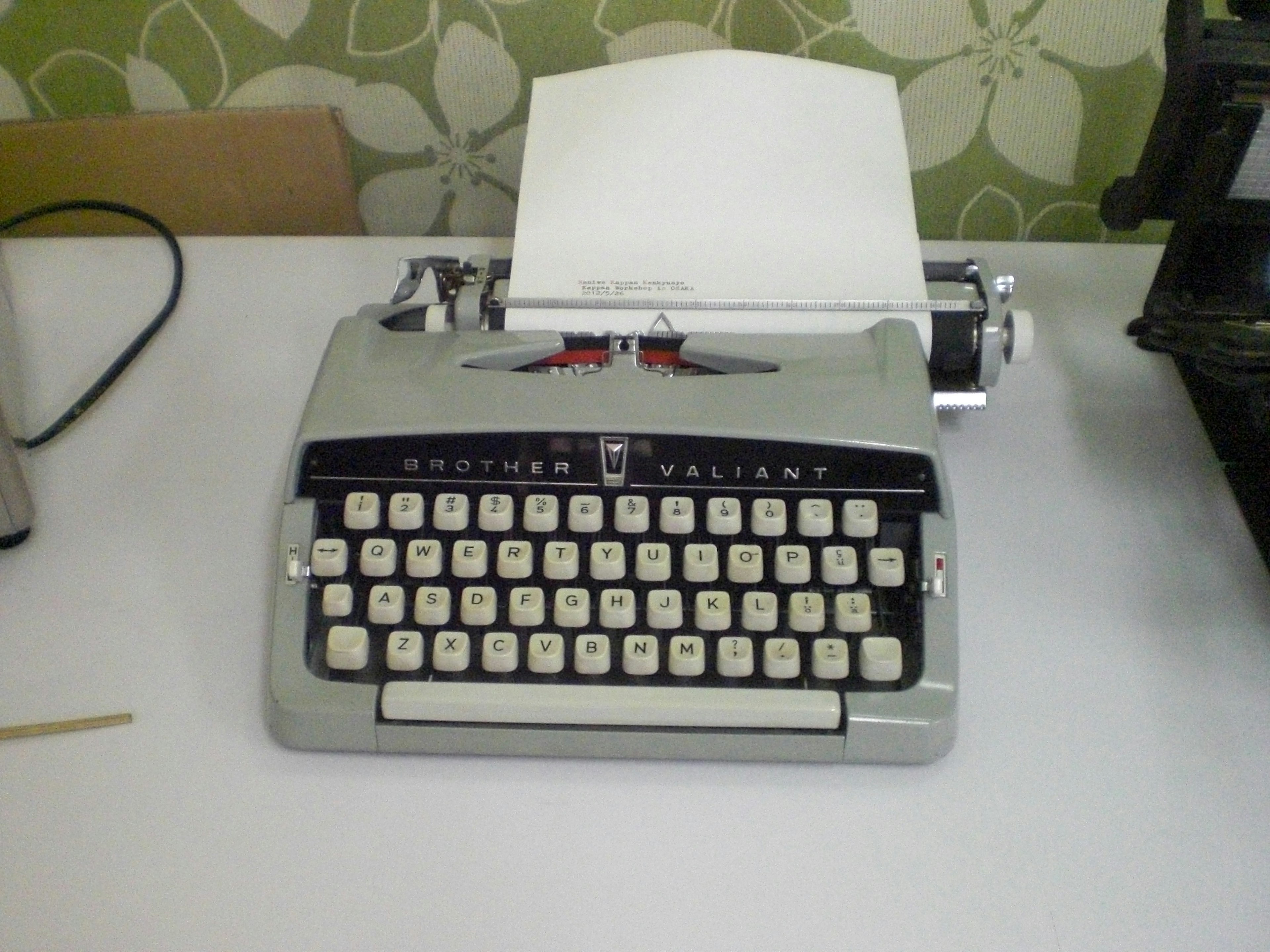 Vintage typewriter with a blank sheet of paper on top