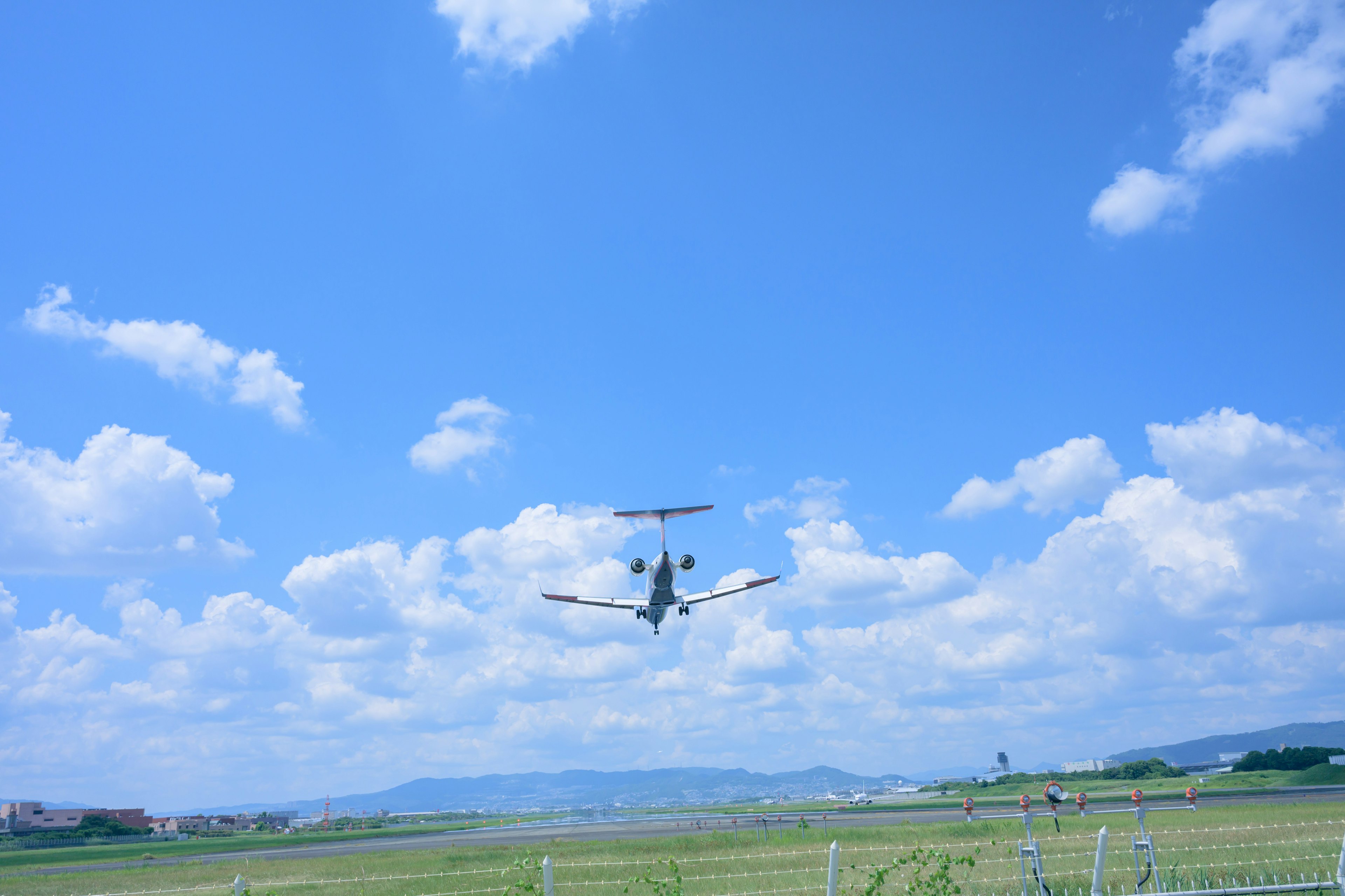 Image of a small aircraft flying under a blue sky