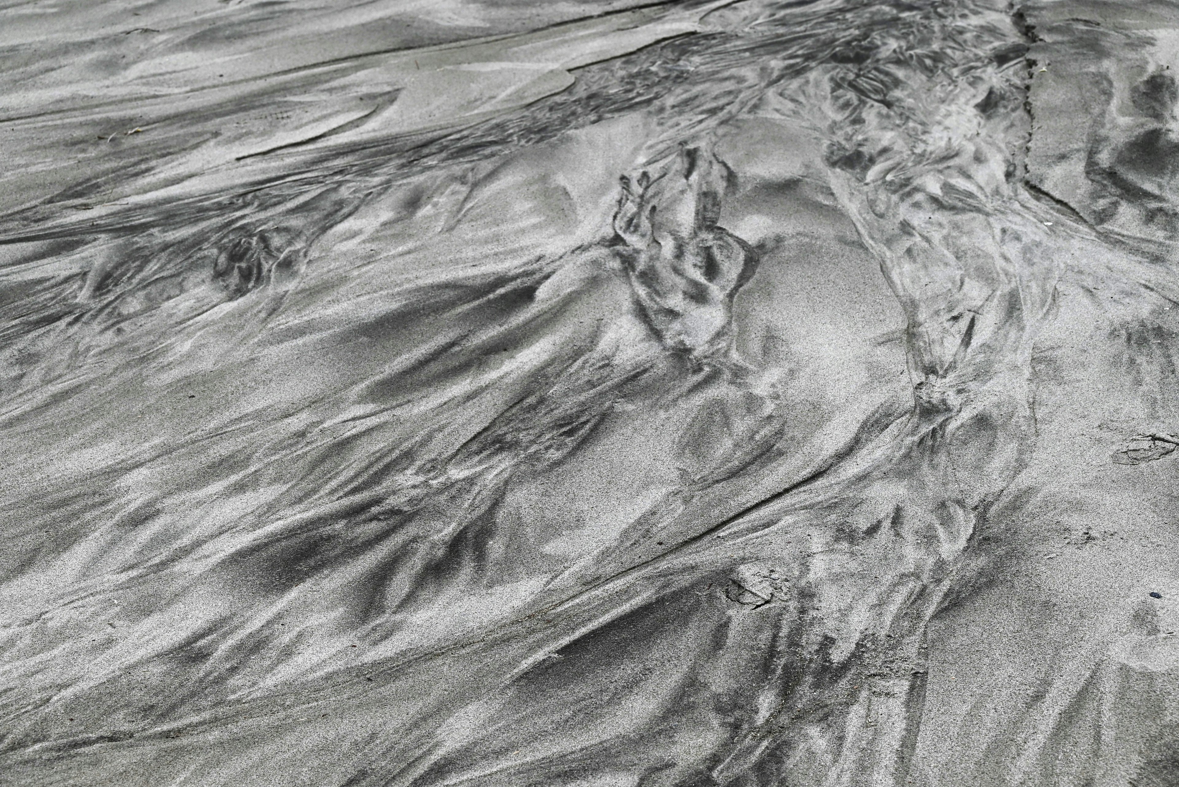 Abstract image featuring flowing silver sand texture