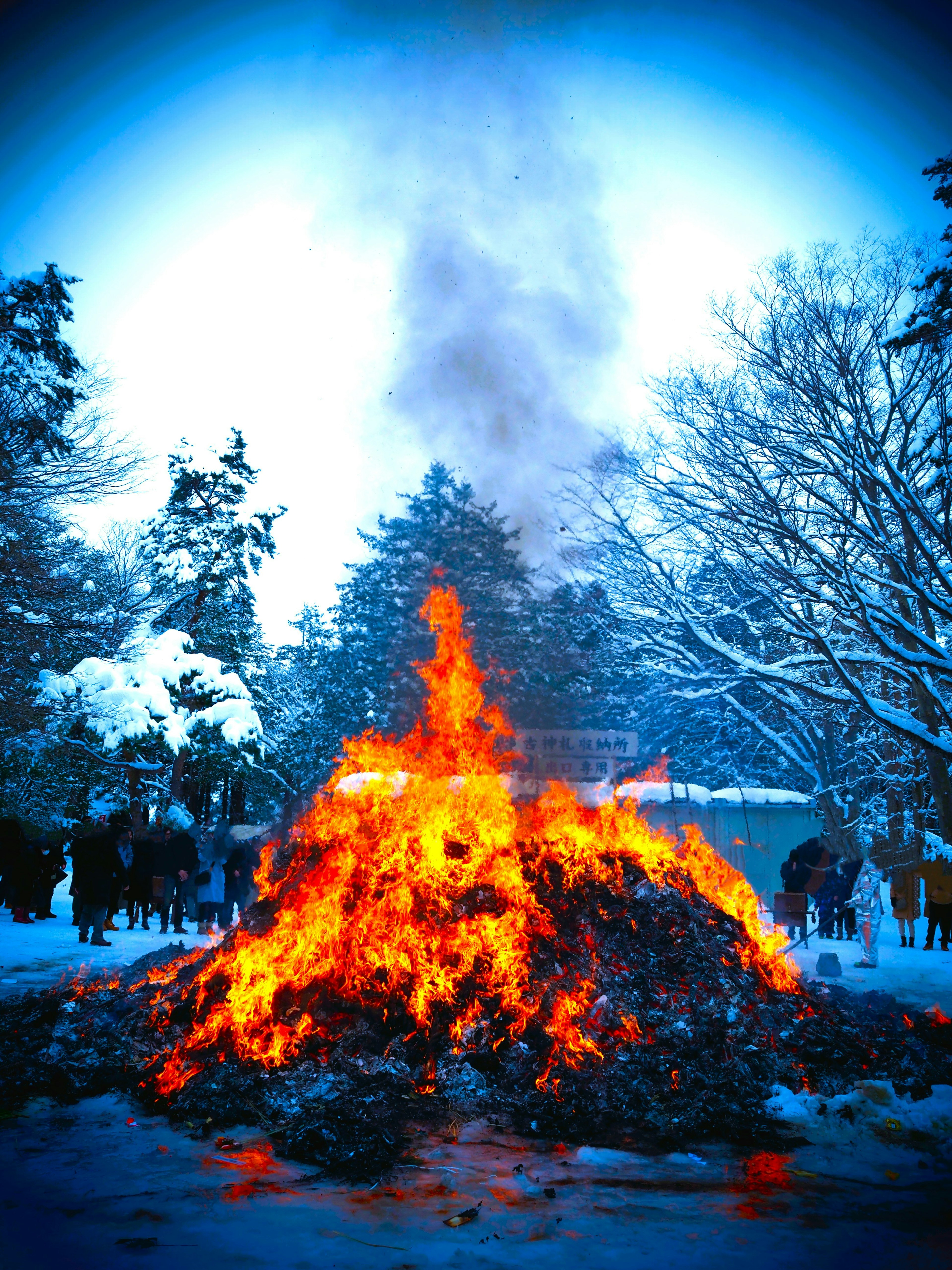 A large bonfire burning in a snowy landscape