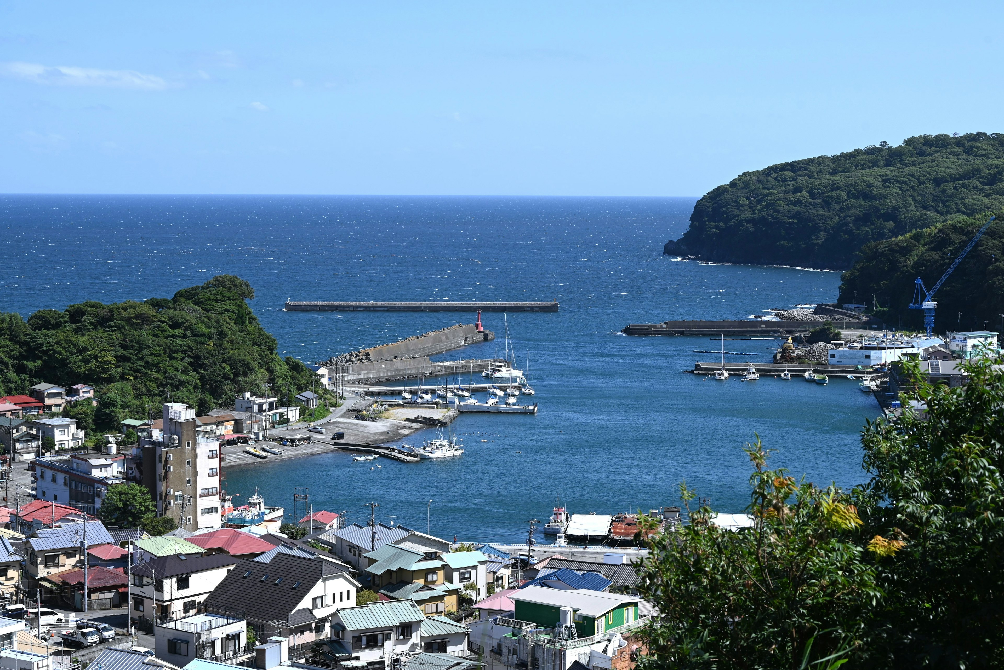 Vista panorámica de una ciudad costera con un puerto y un océano azul