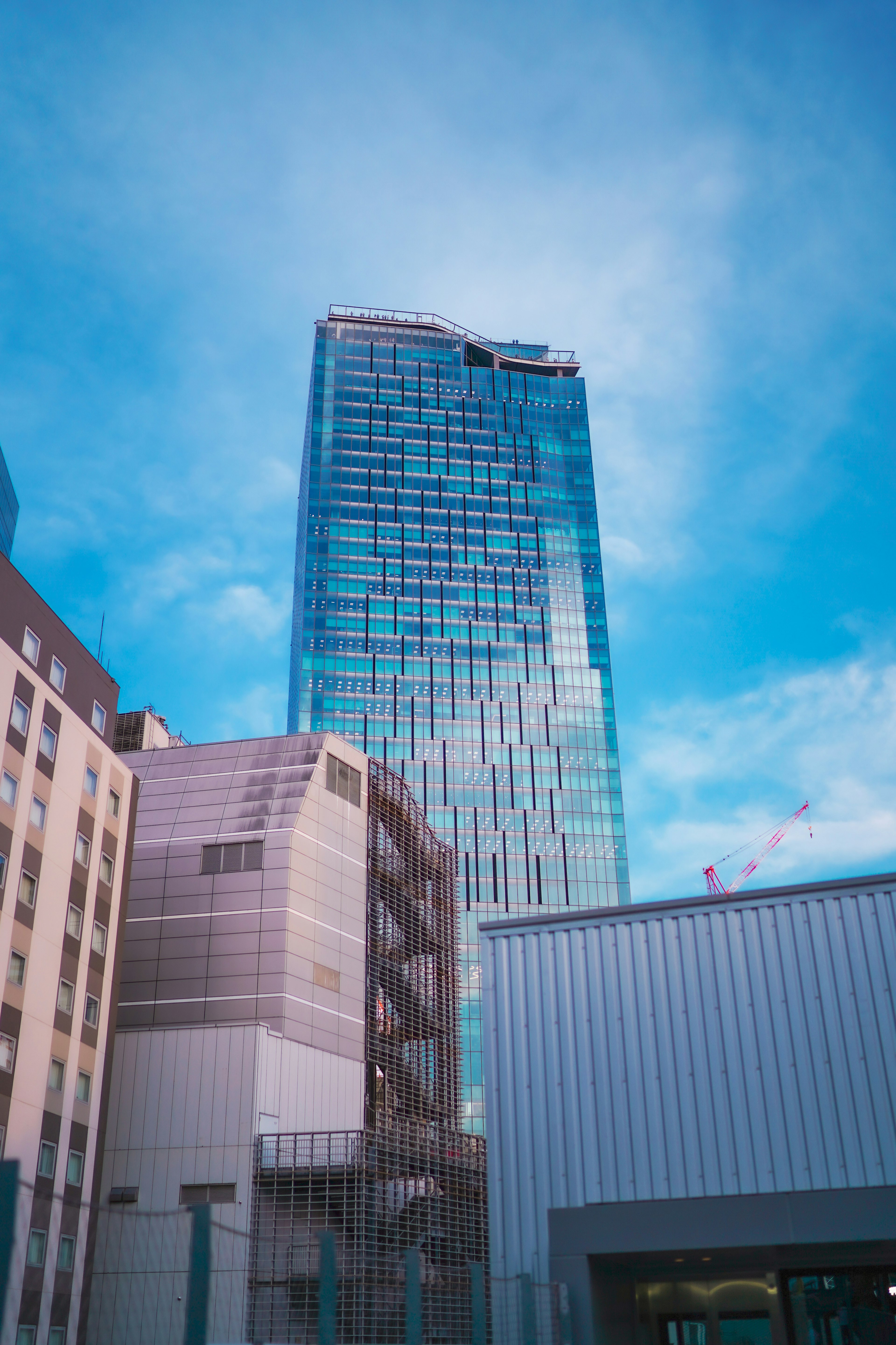 Tall skyscraper under a blue sky