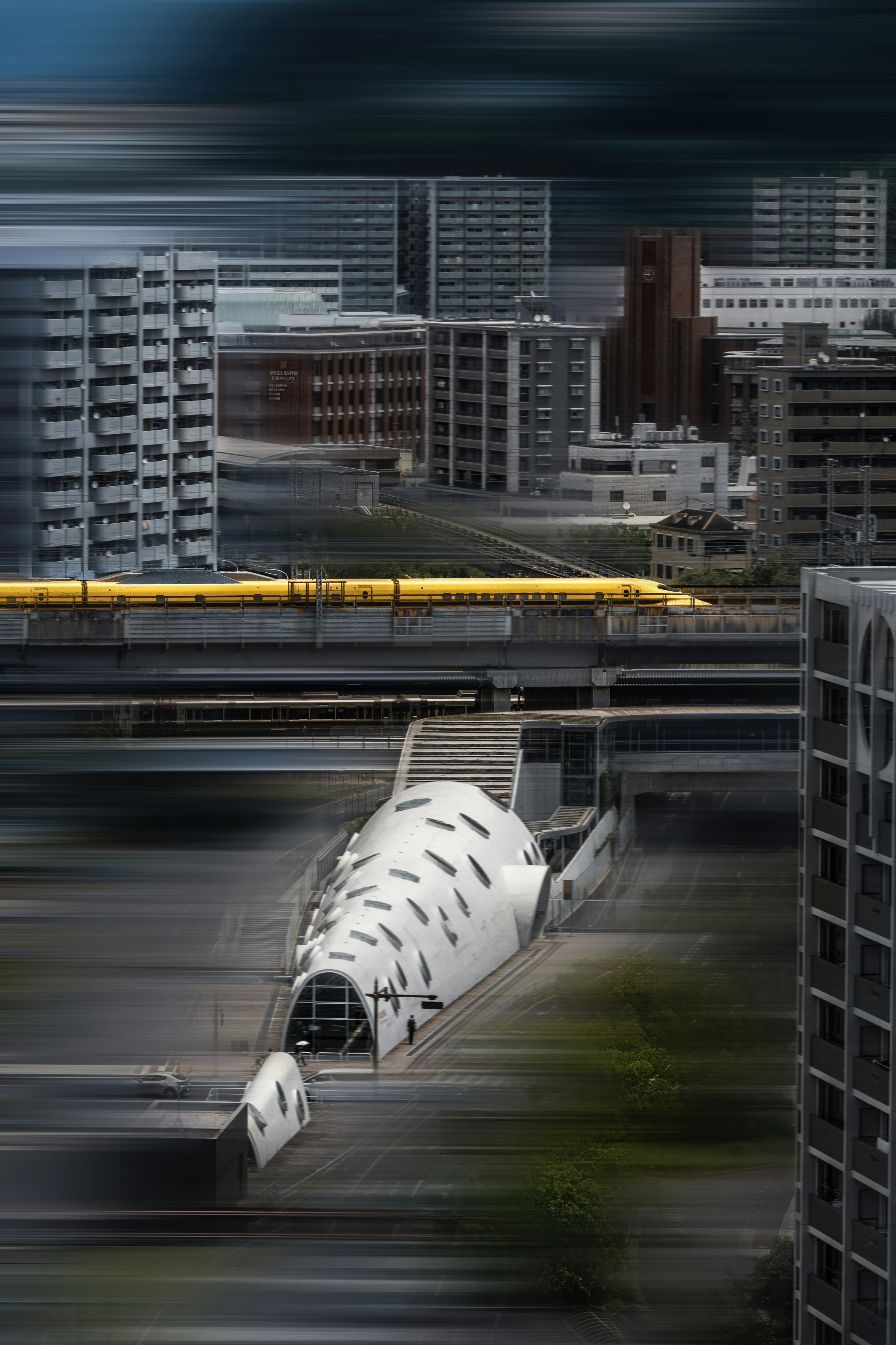 Futuristic building design with a yellow train in an urban landscape