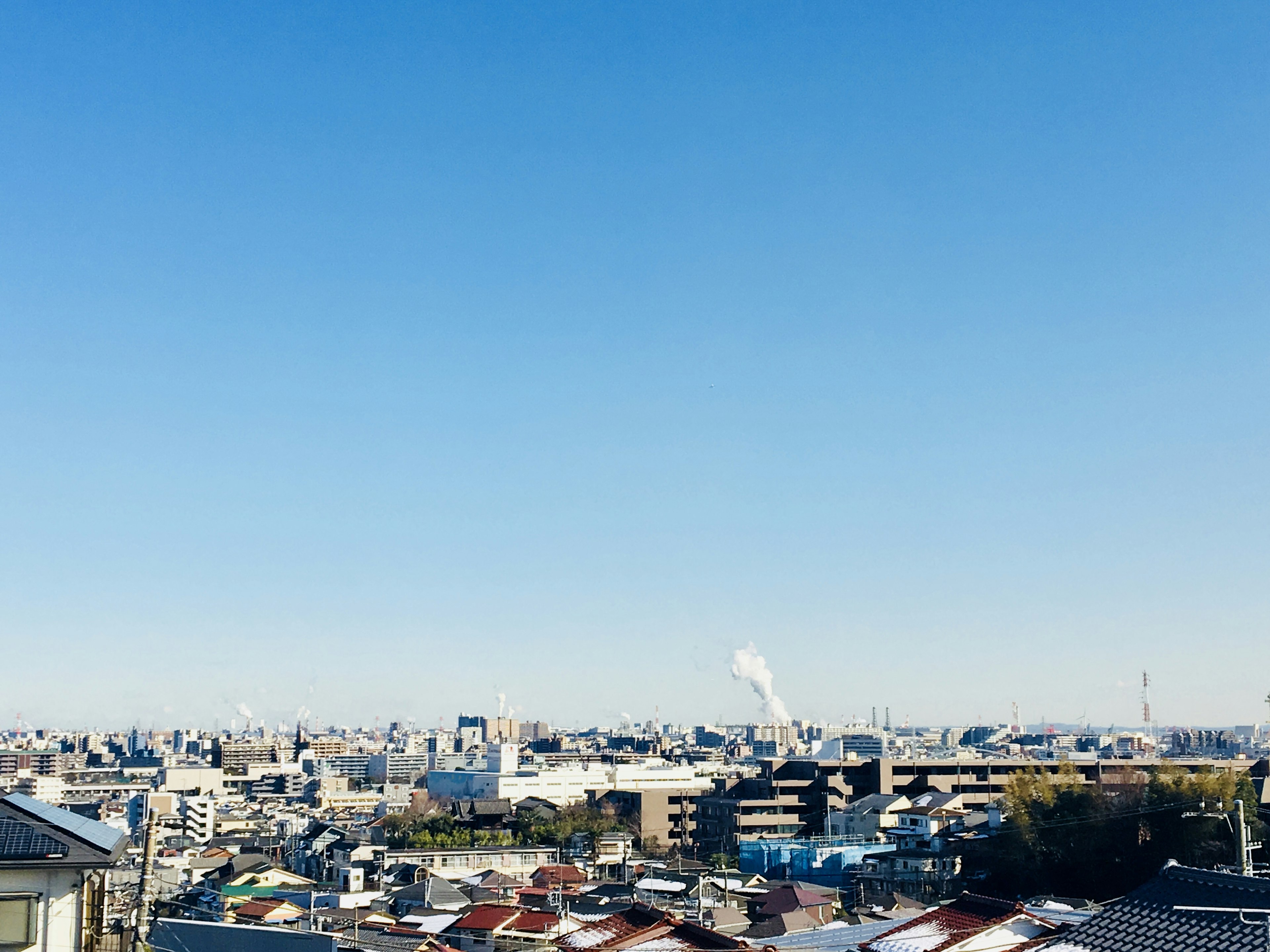 Panoramic view of a city under a clear blue sky