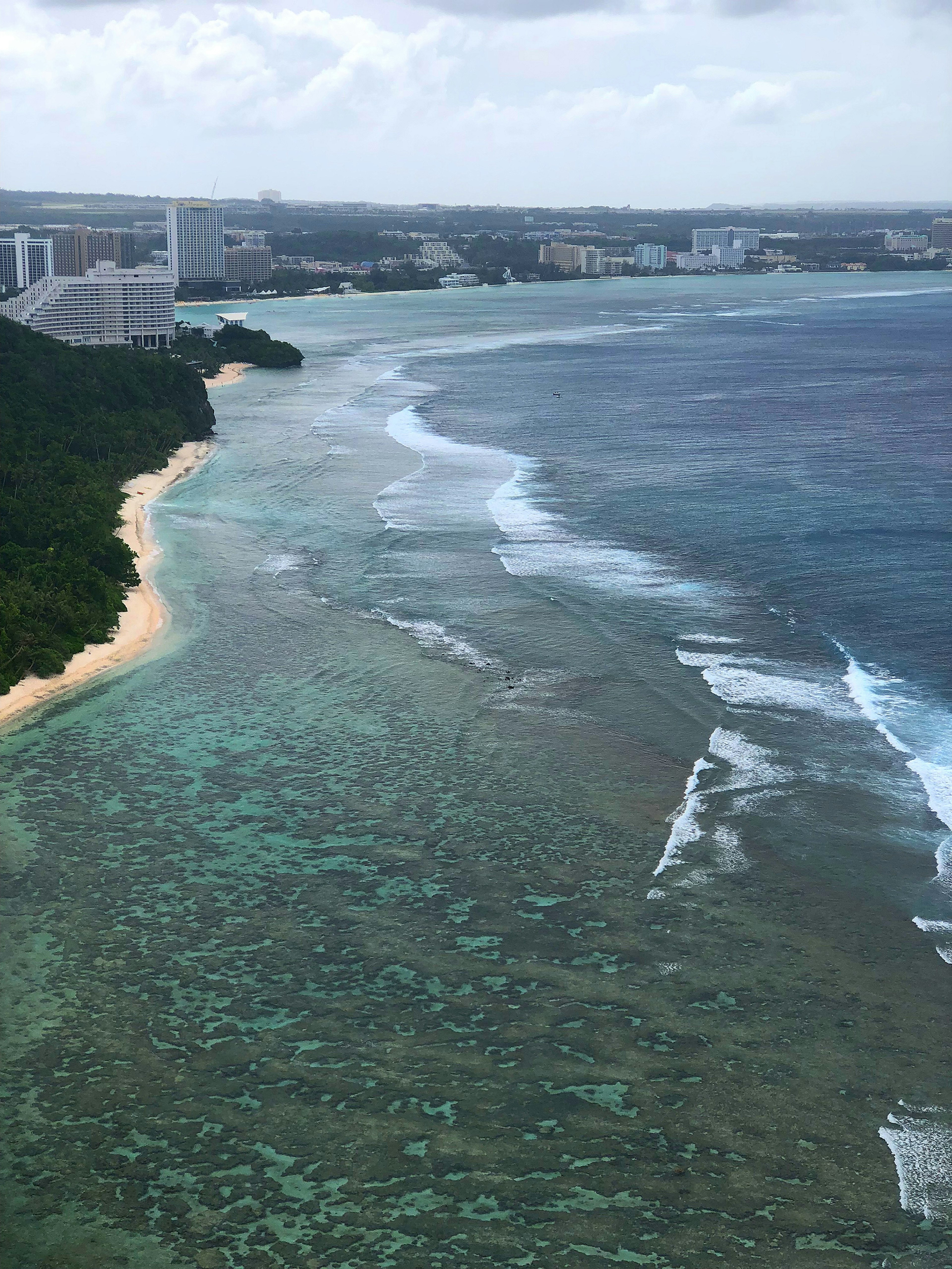 Beautiful landscape featuring blue sea, white waves, and green islands