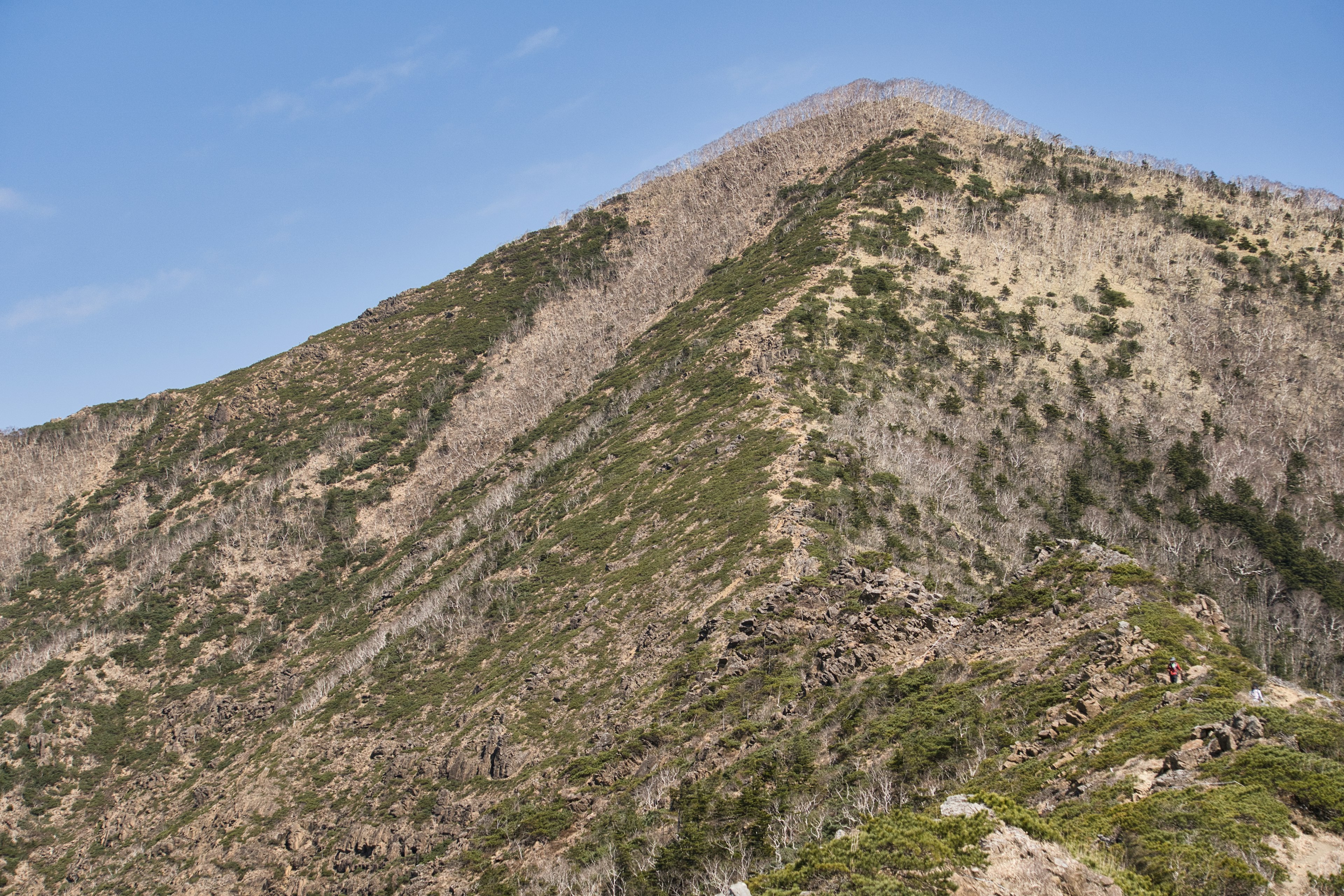 Mountain landscape with green slopes and rocky terrain