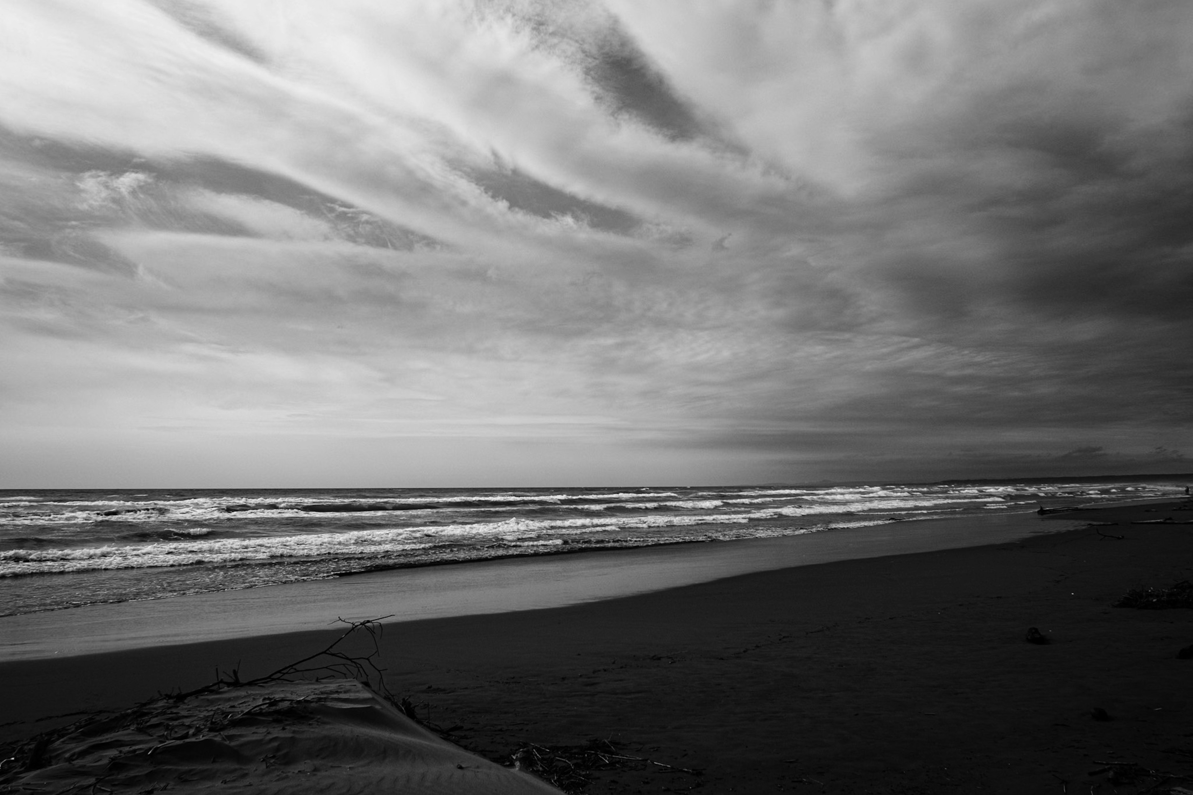 Black and white coastal landscape Waves and cloud patterns create a dramatic scene