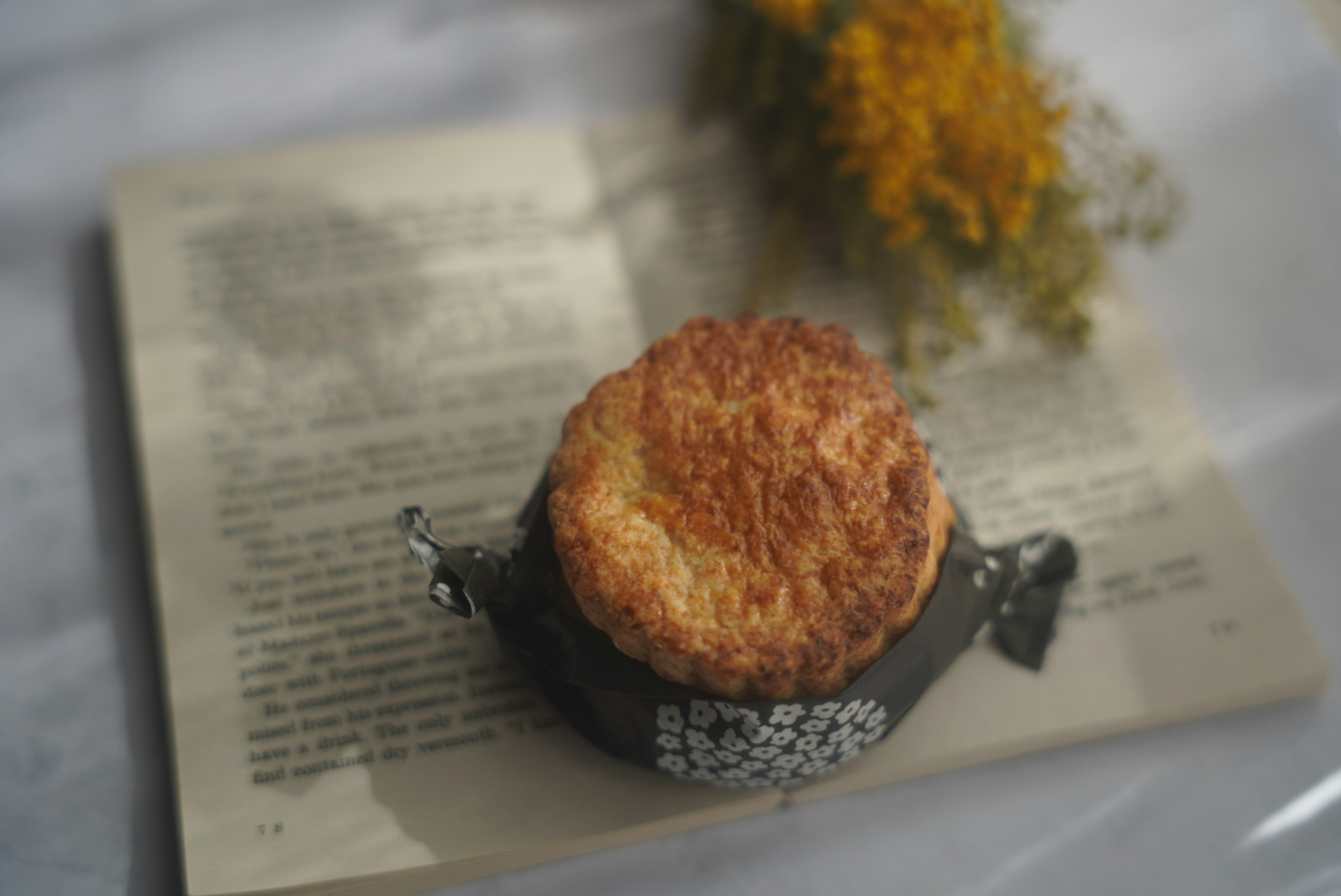 Baked good placed on a book with flowers