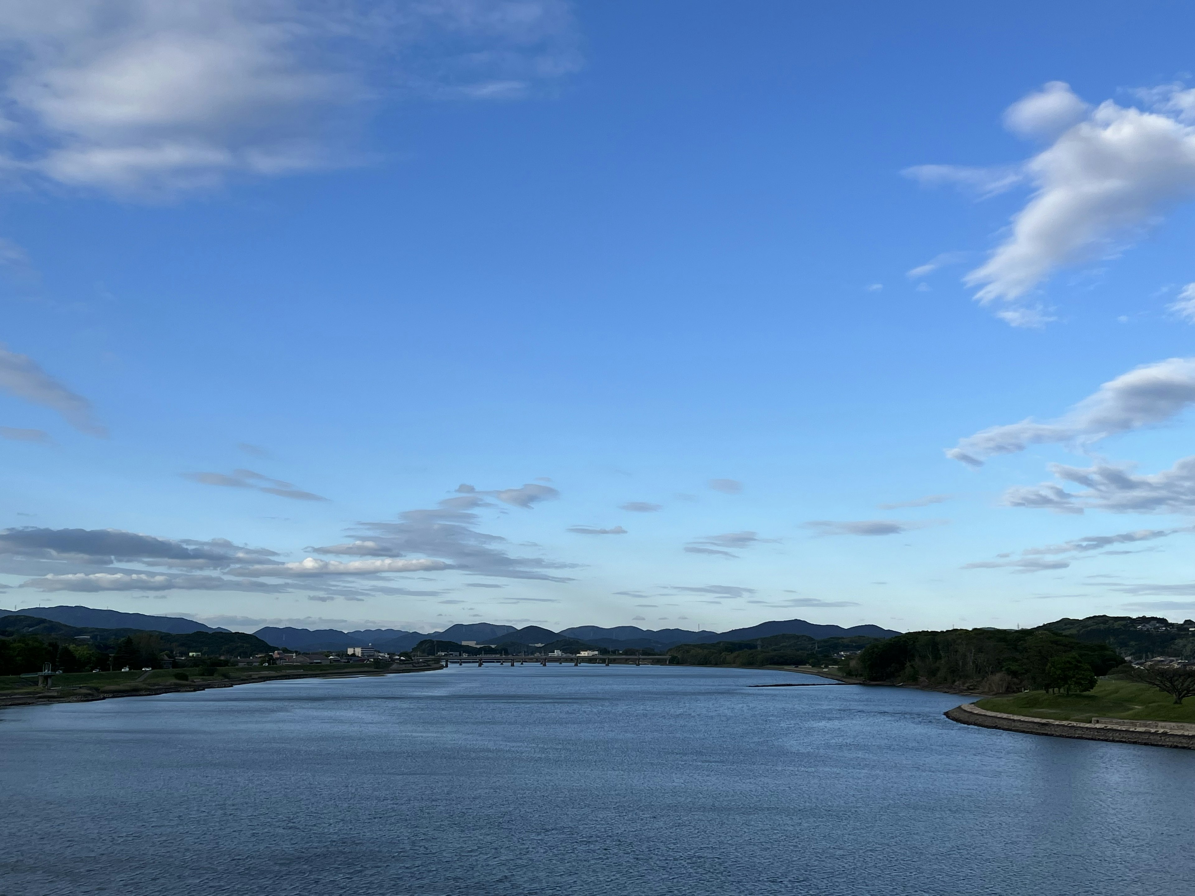 Vue pittoresque d'une rivière sous un ciel bleu avec des nuages