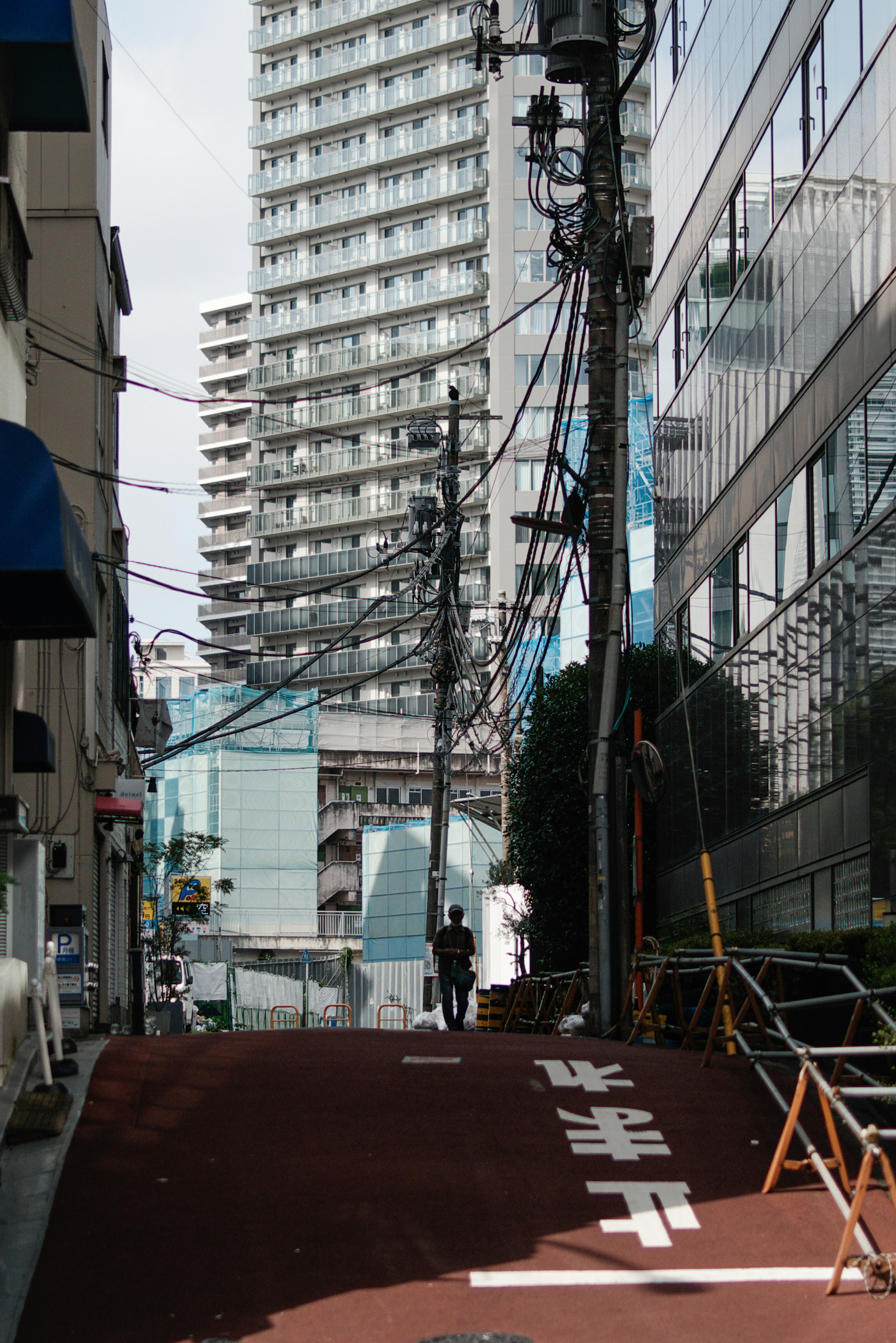 Urban street view featuring a high-rise building and utility poles