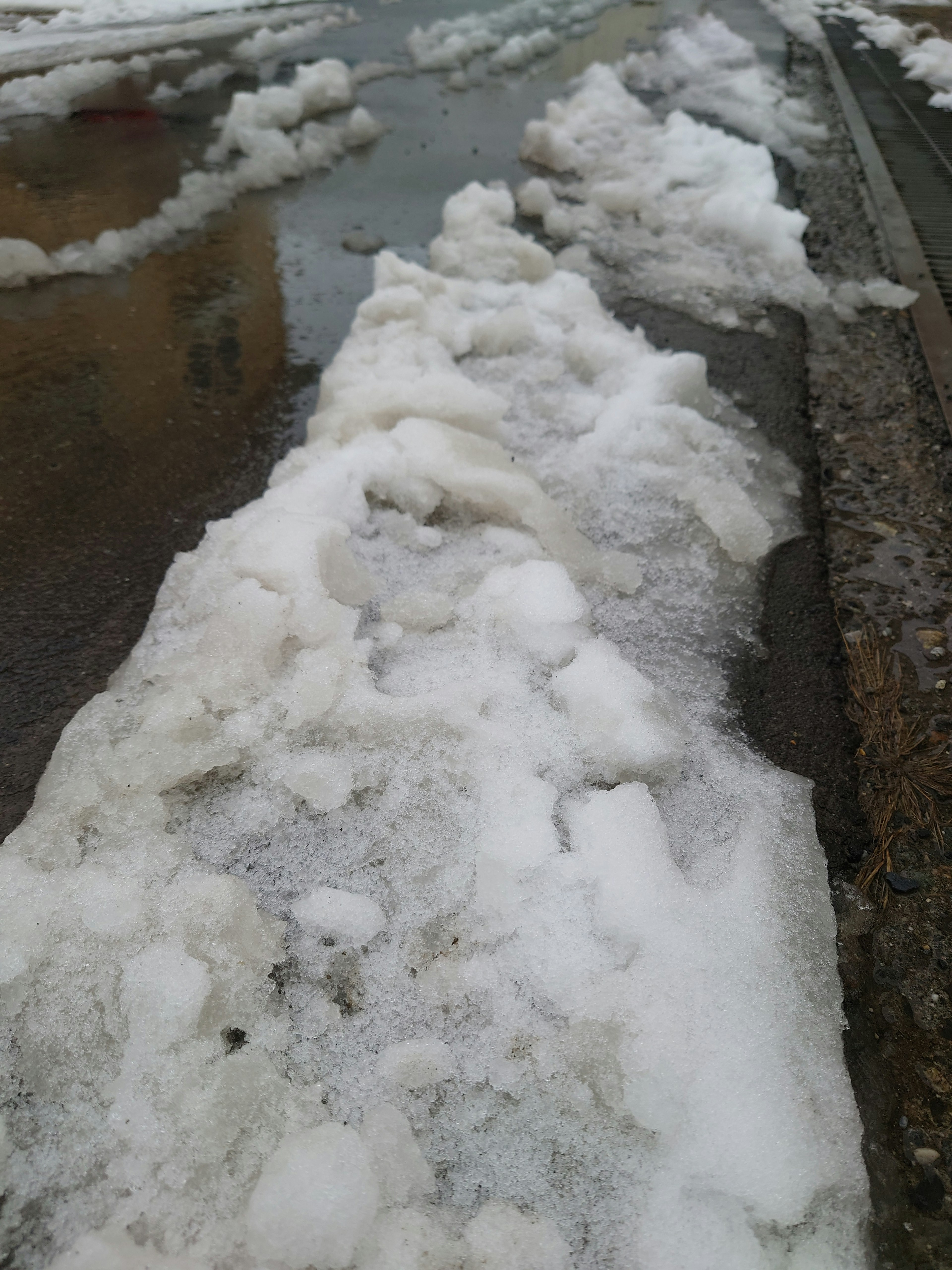 A view of a path covered with snow and mixed water