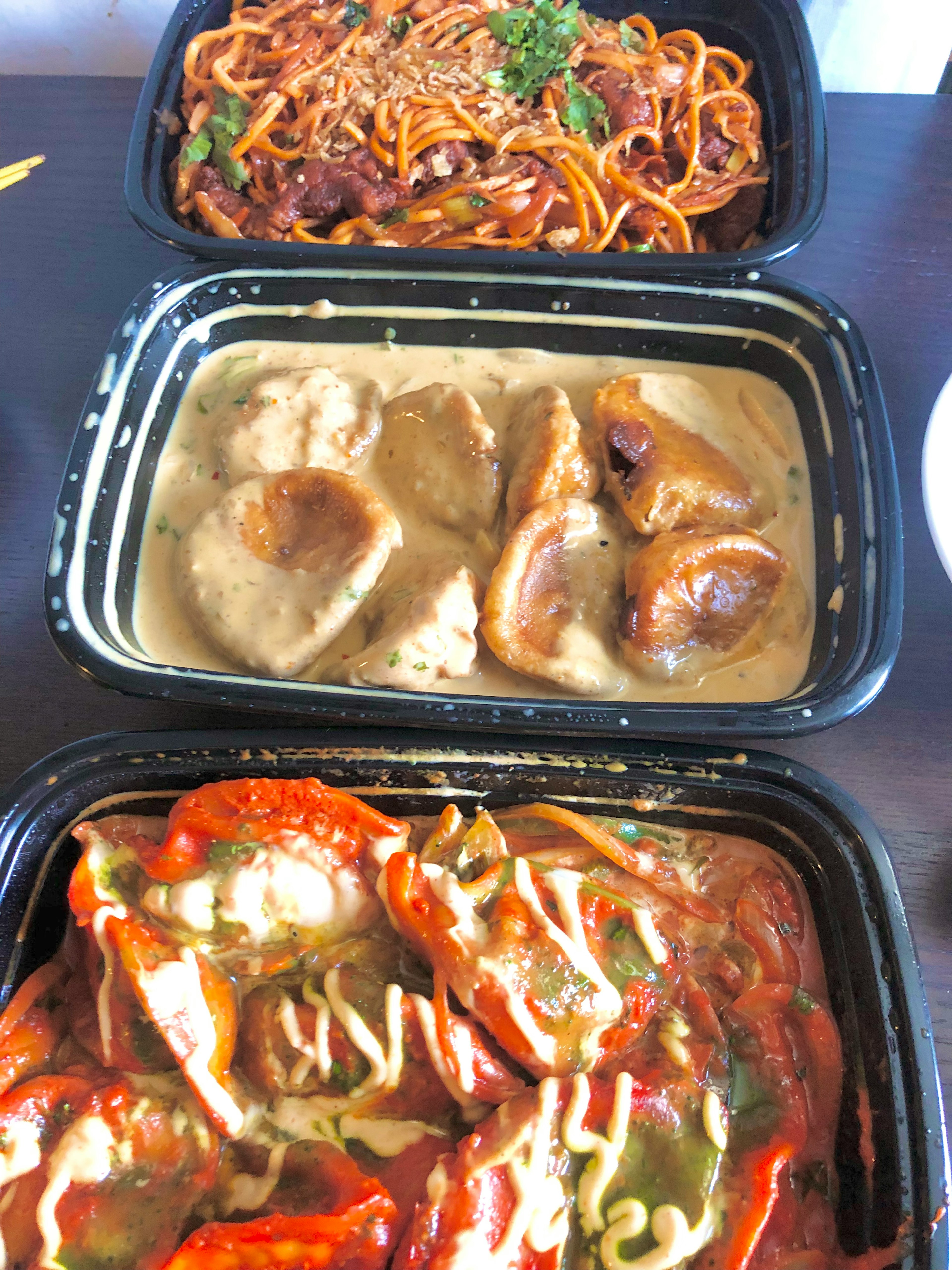 Image of three takeout boxes featuring different dishes