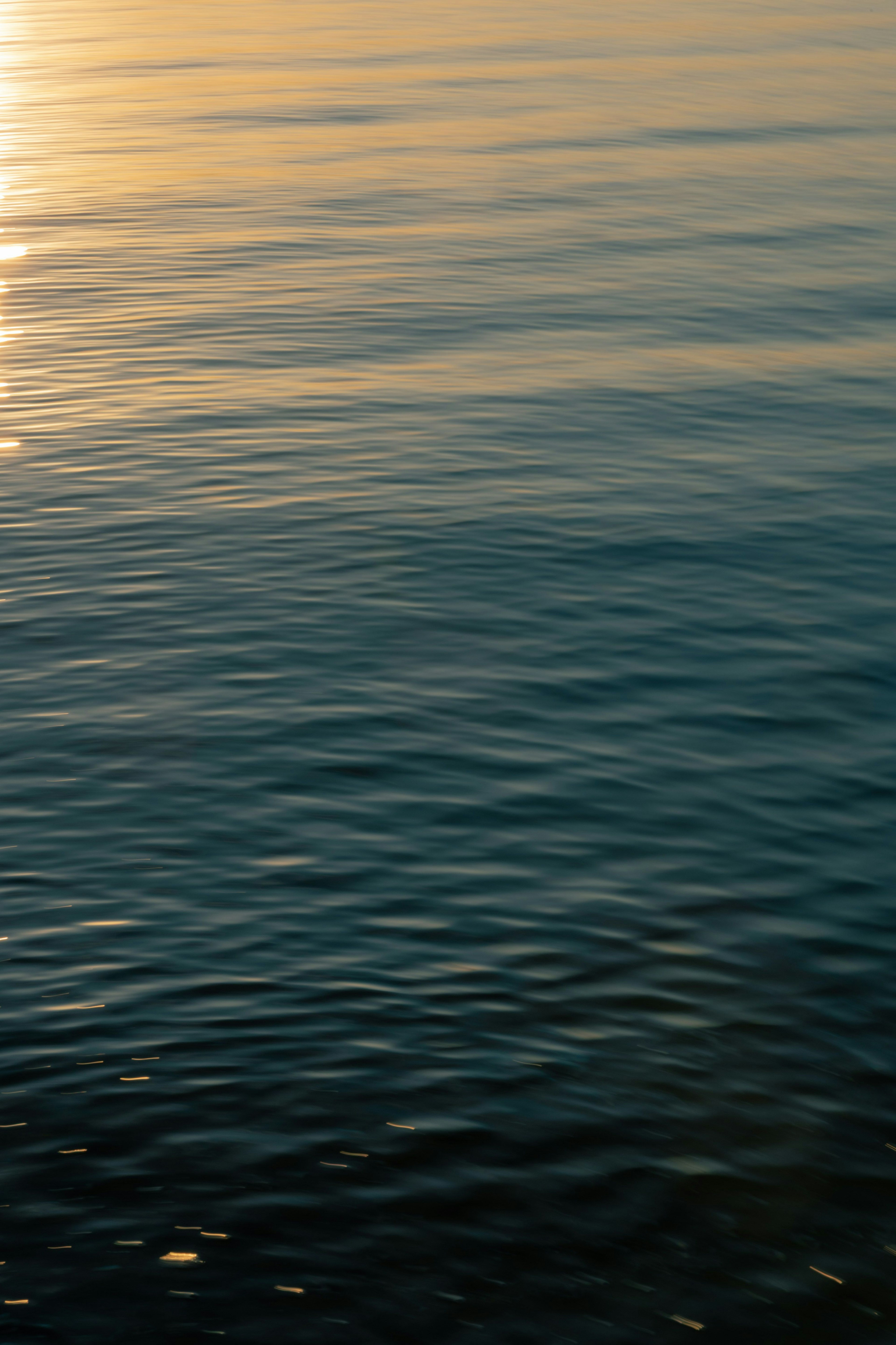 穏やかな水面に反射する夕日の光