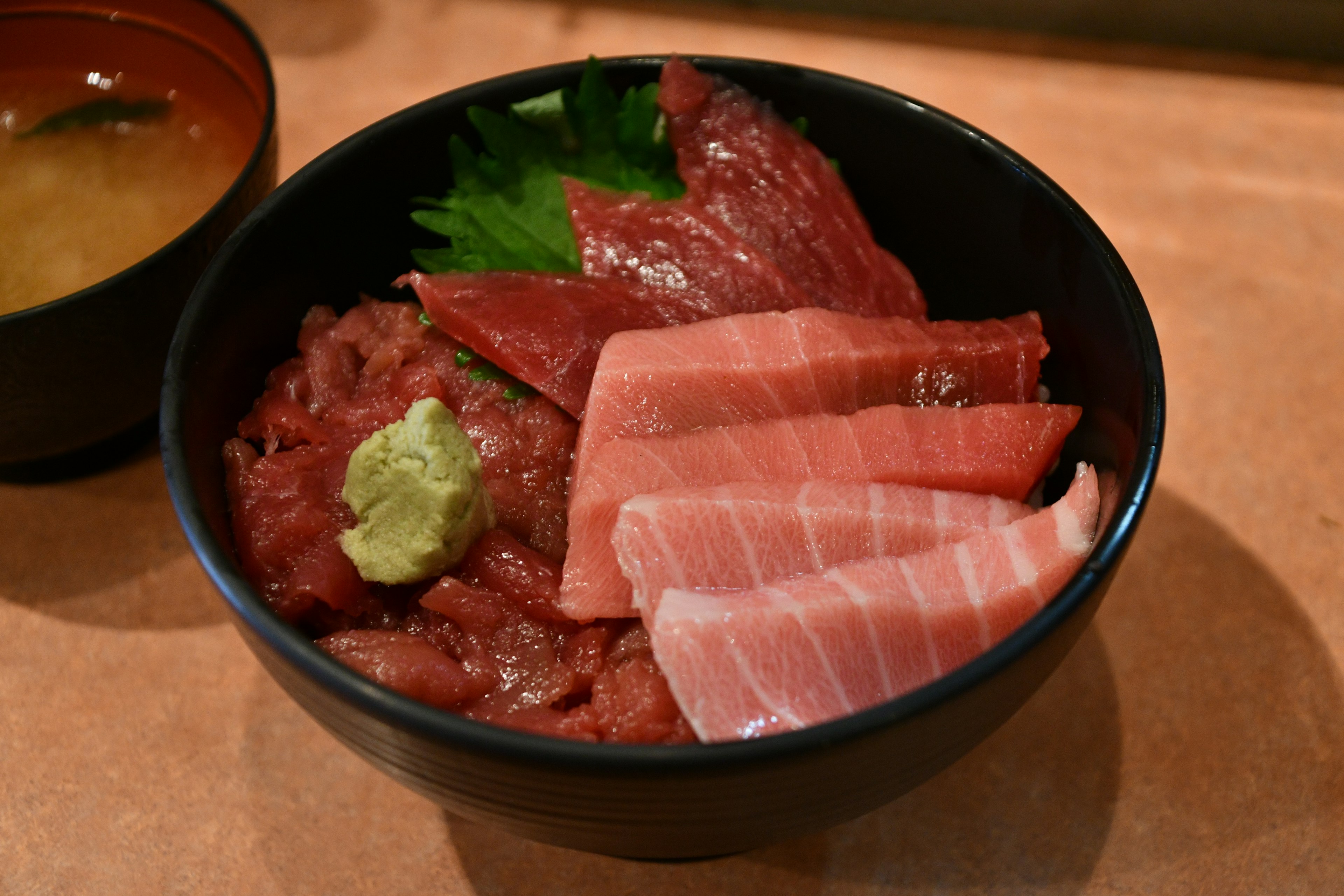 Bowl of fresh sashimi with wasabi and garnishes