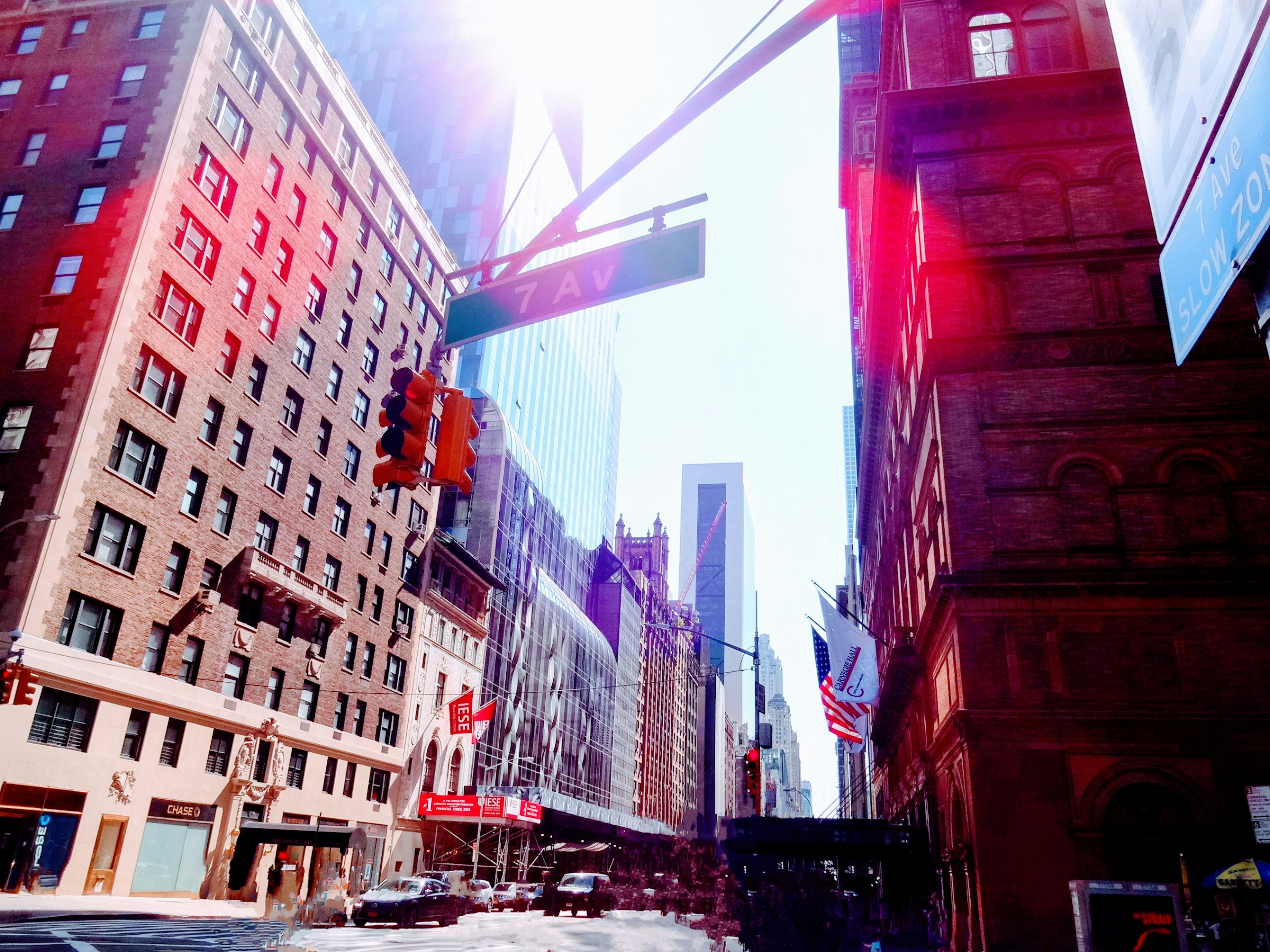 New York City street with tall buildings under bright sunlight