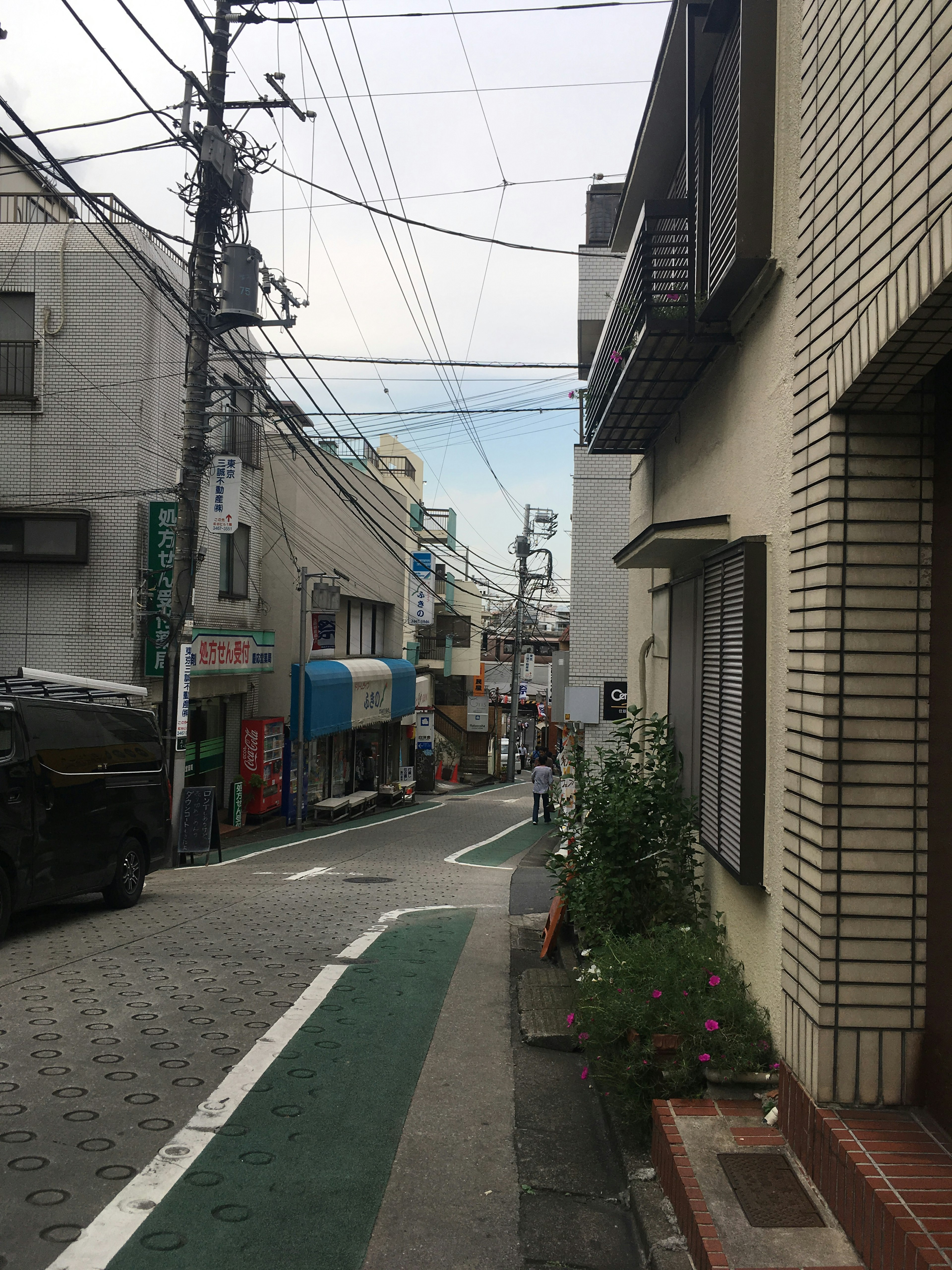 Street view with buildings and power lines in a narrow alley