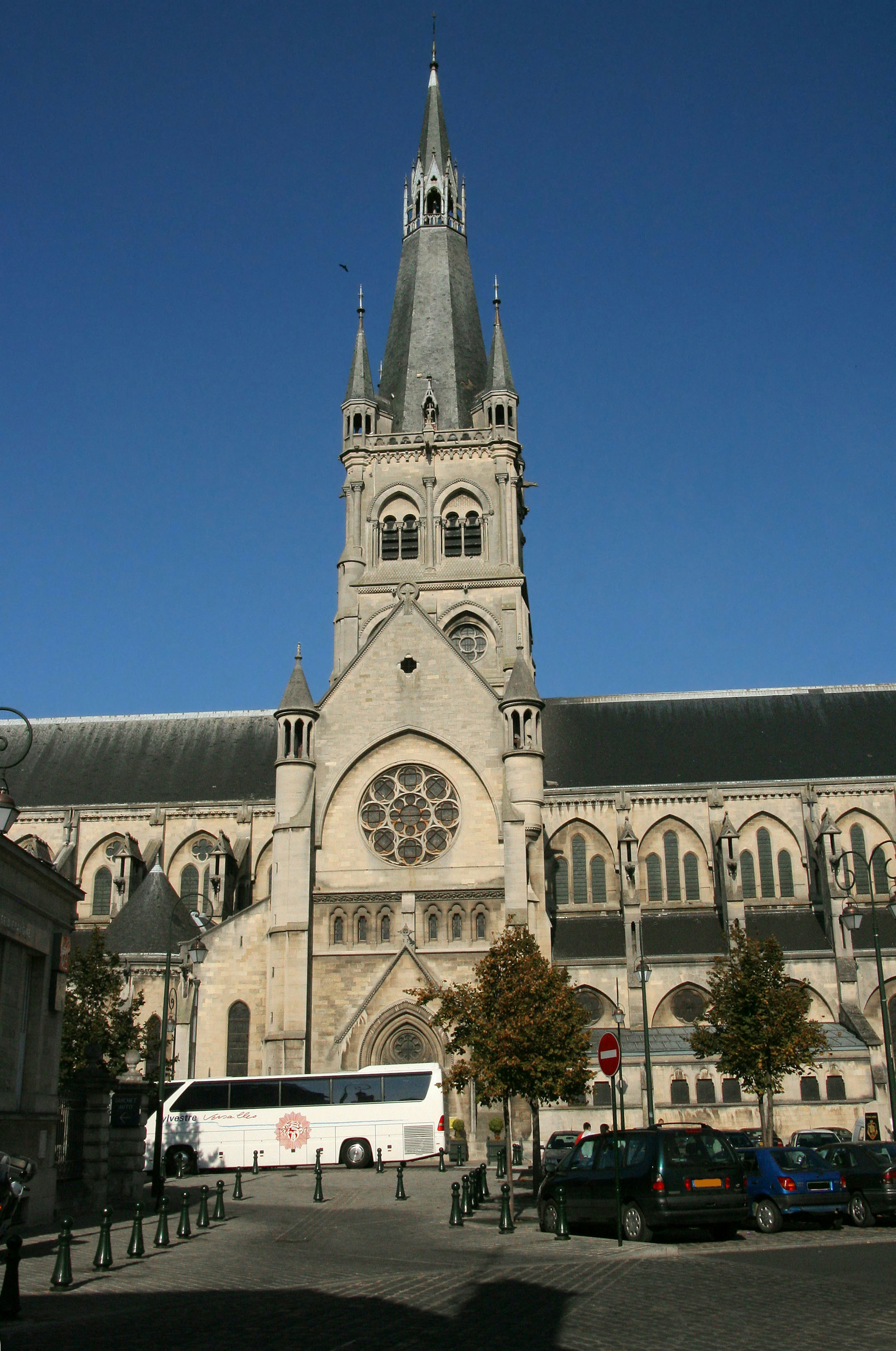 Church tower with Gothic architecture against a clear blue sky