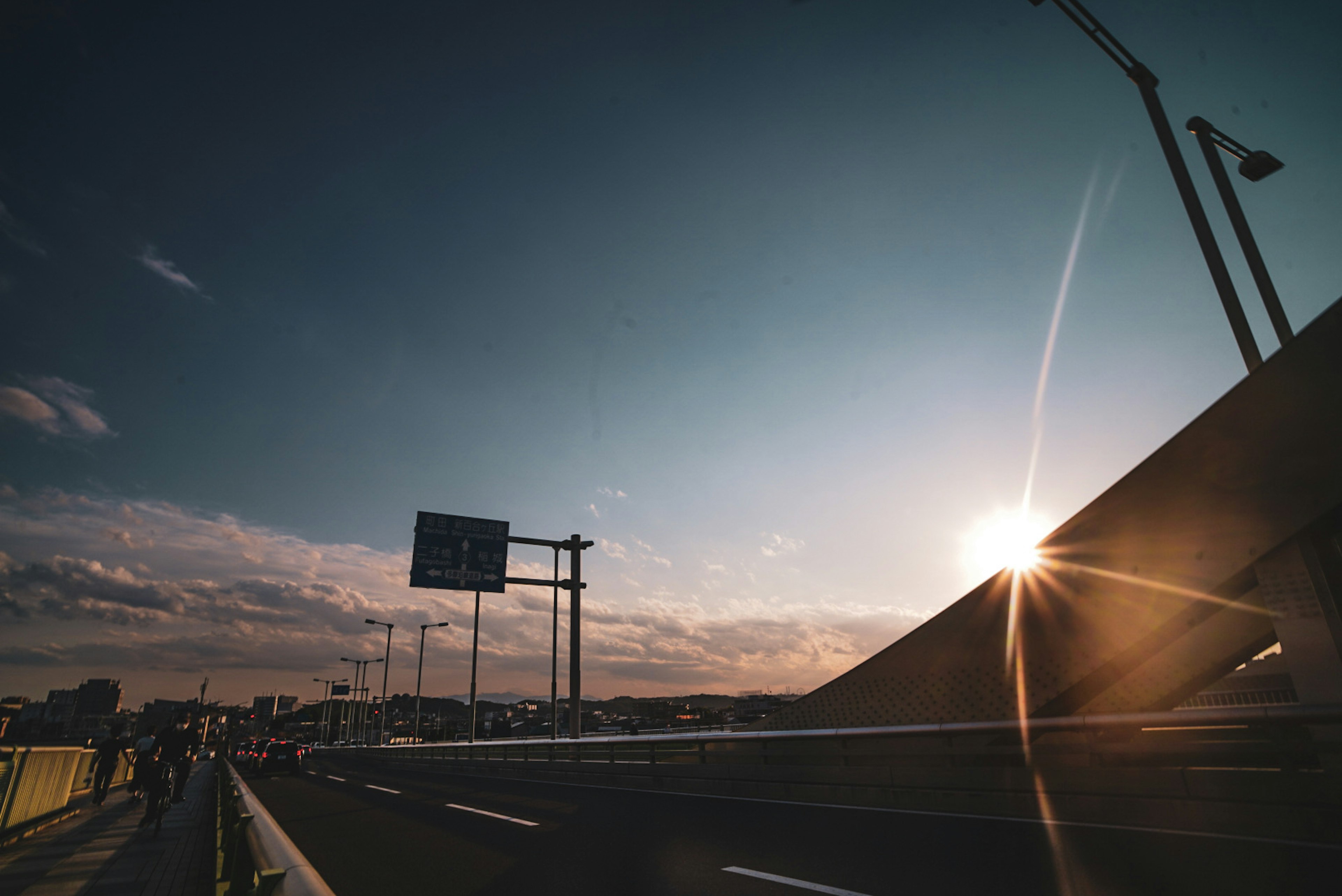 Eine malerische Ansicht einer Brücke mit Sonnenuntergang und Straße