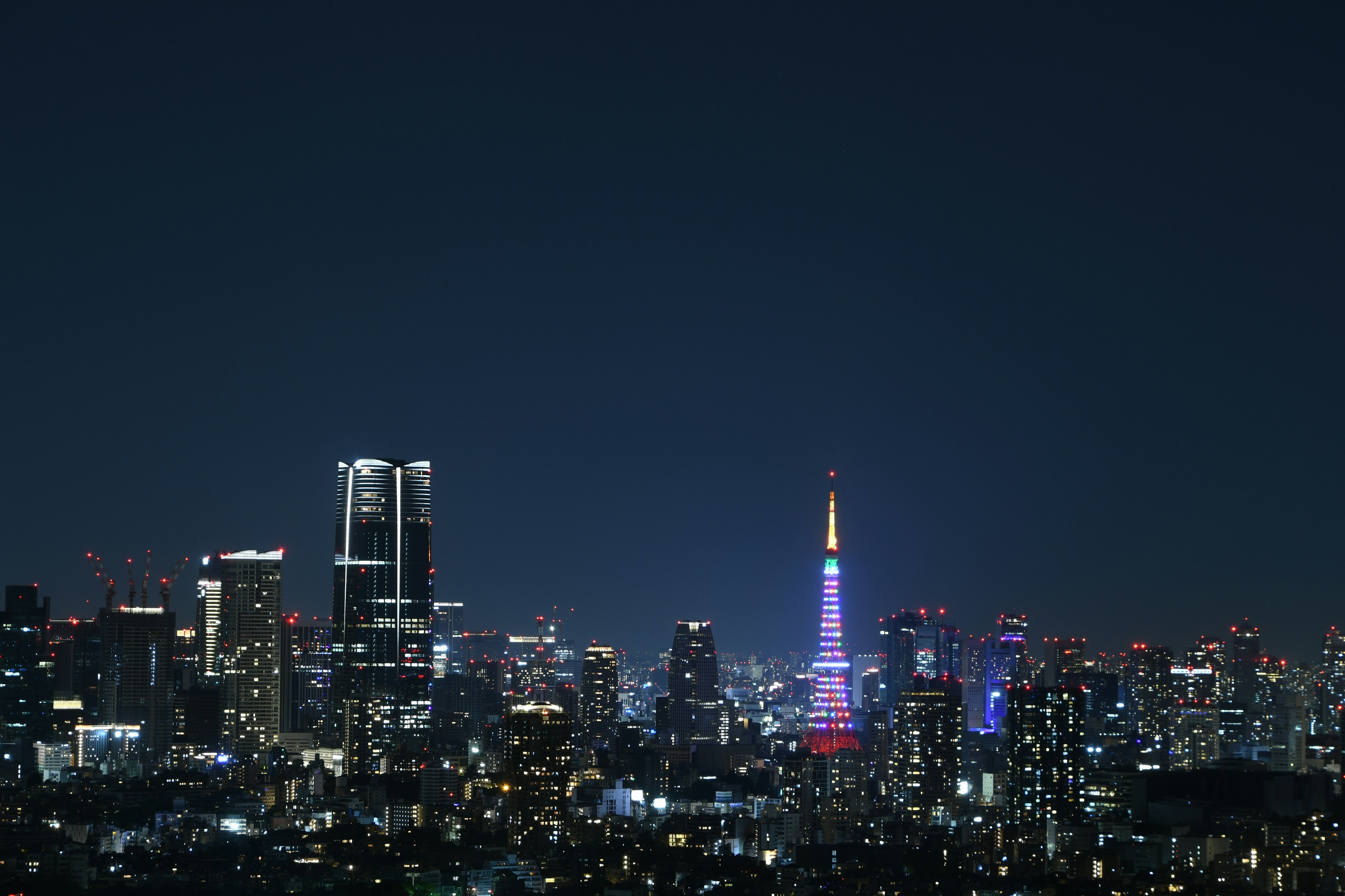 Tokyo Tower illuminated at night with city skyline