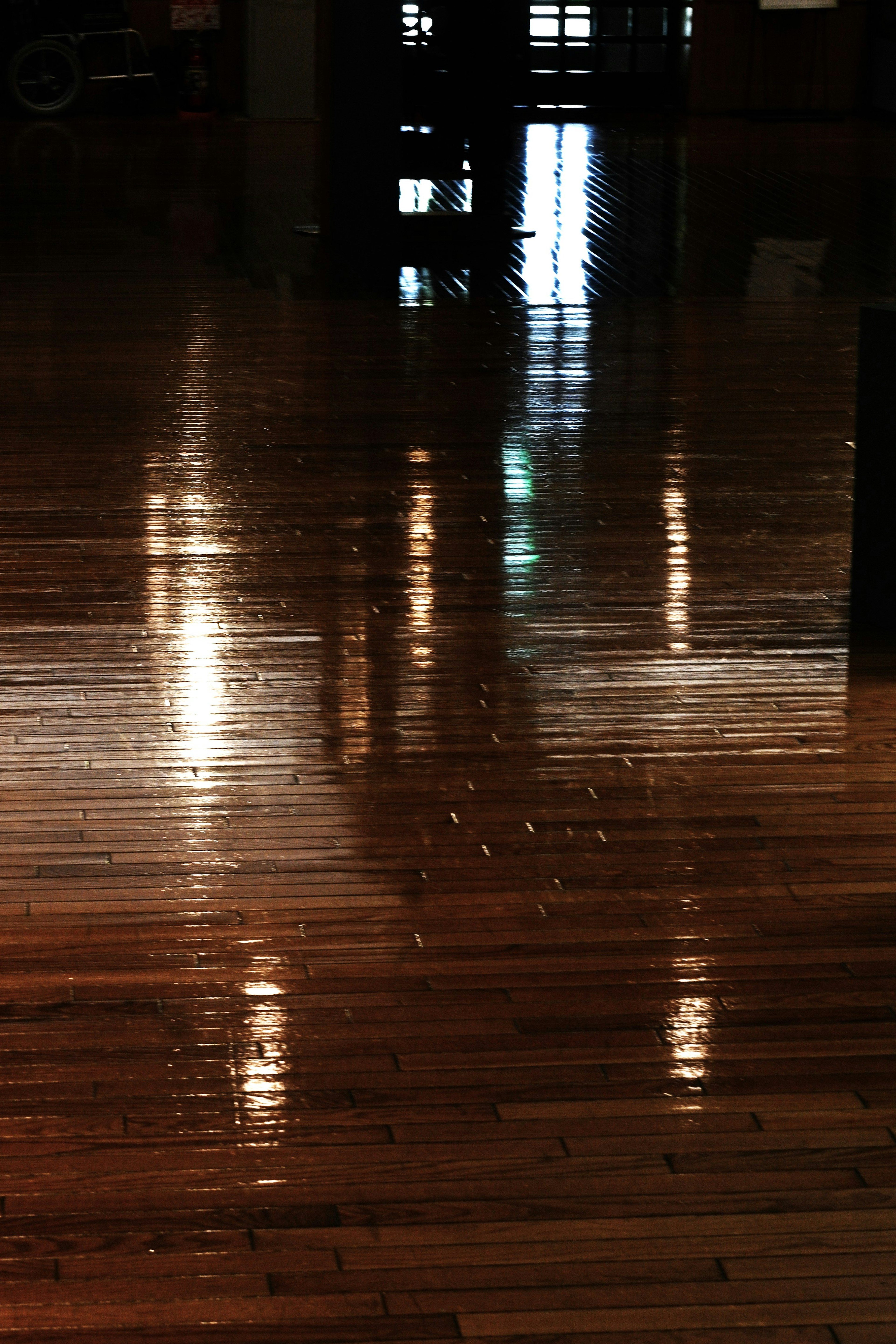 Shiny wooden floor reflecting light in a serene space