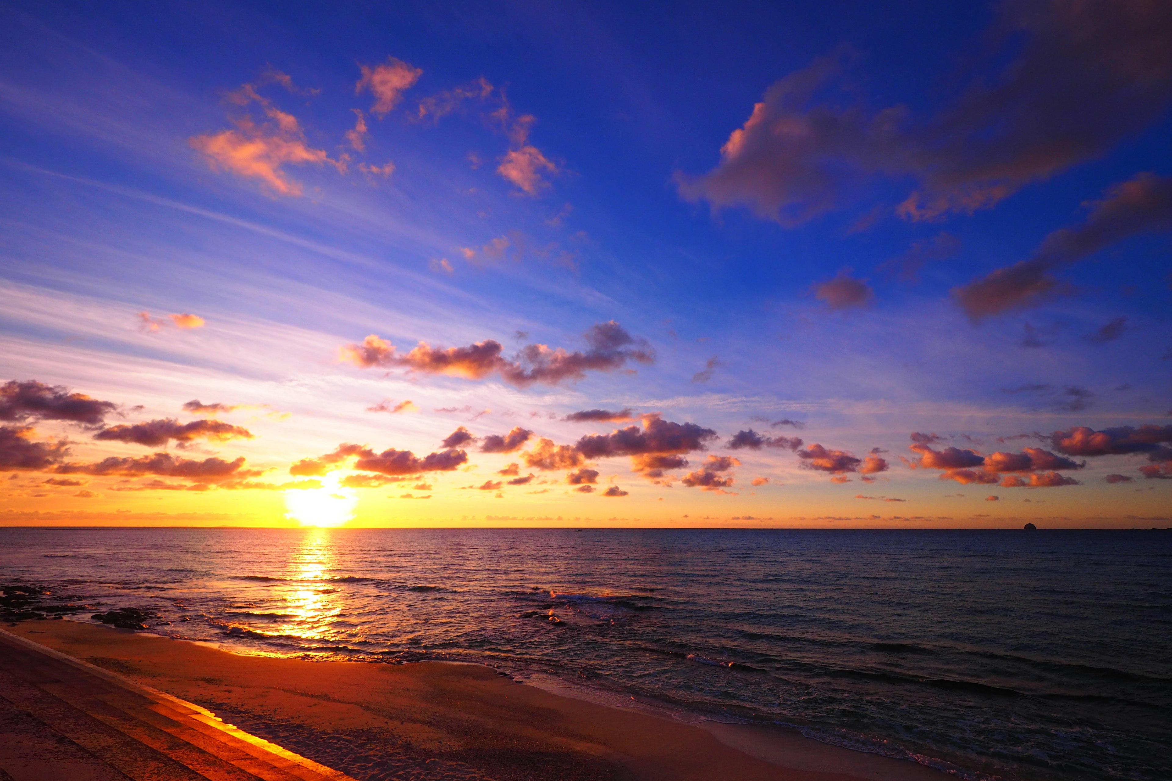 Beautiful sunset over the ocean Sky features shades of blue and orange