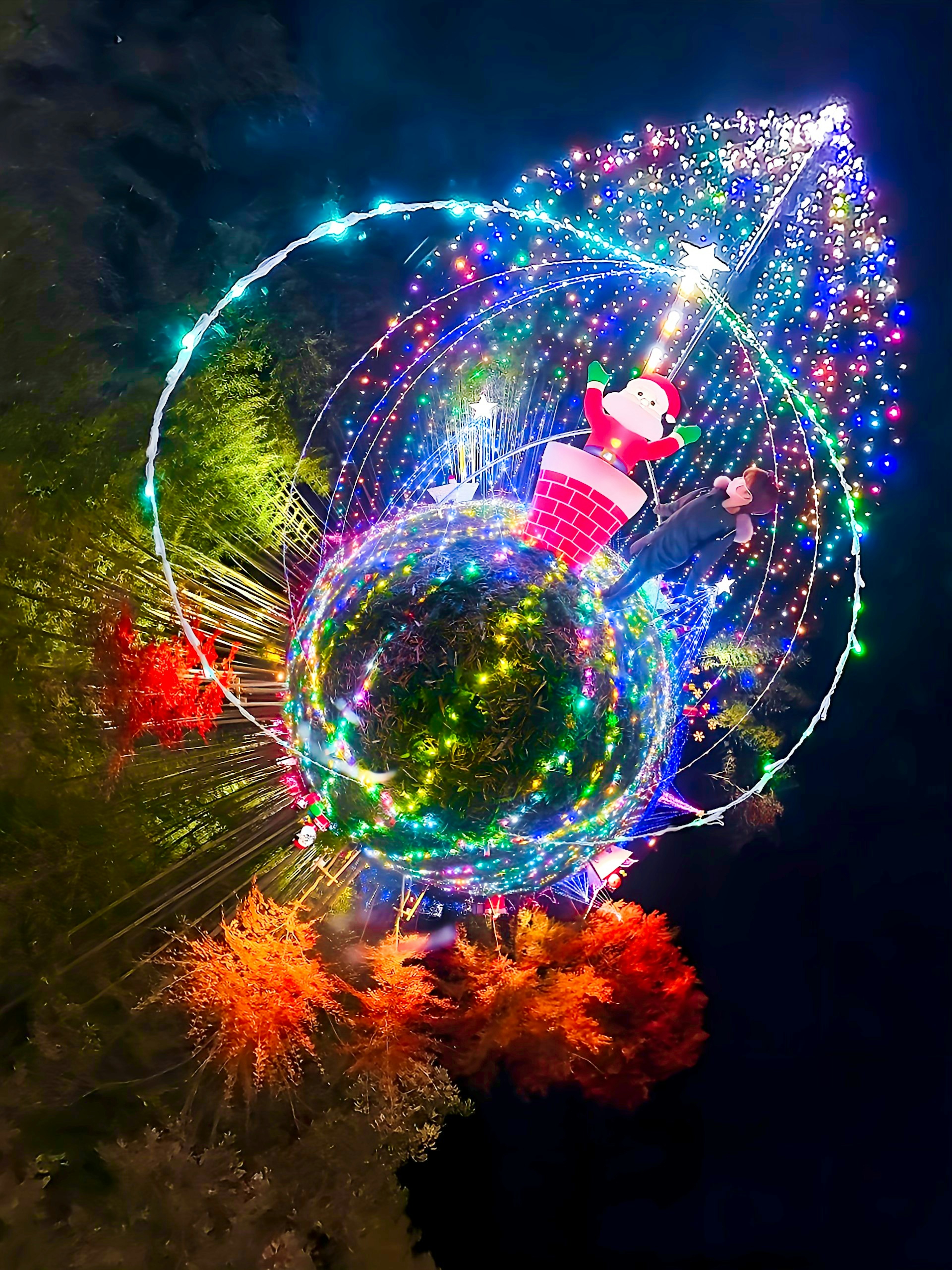 Colorful Christmas tree with Santa decorations in a night scene