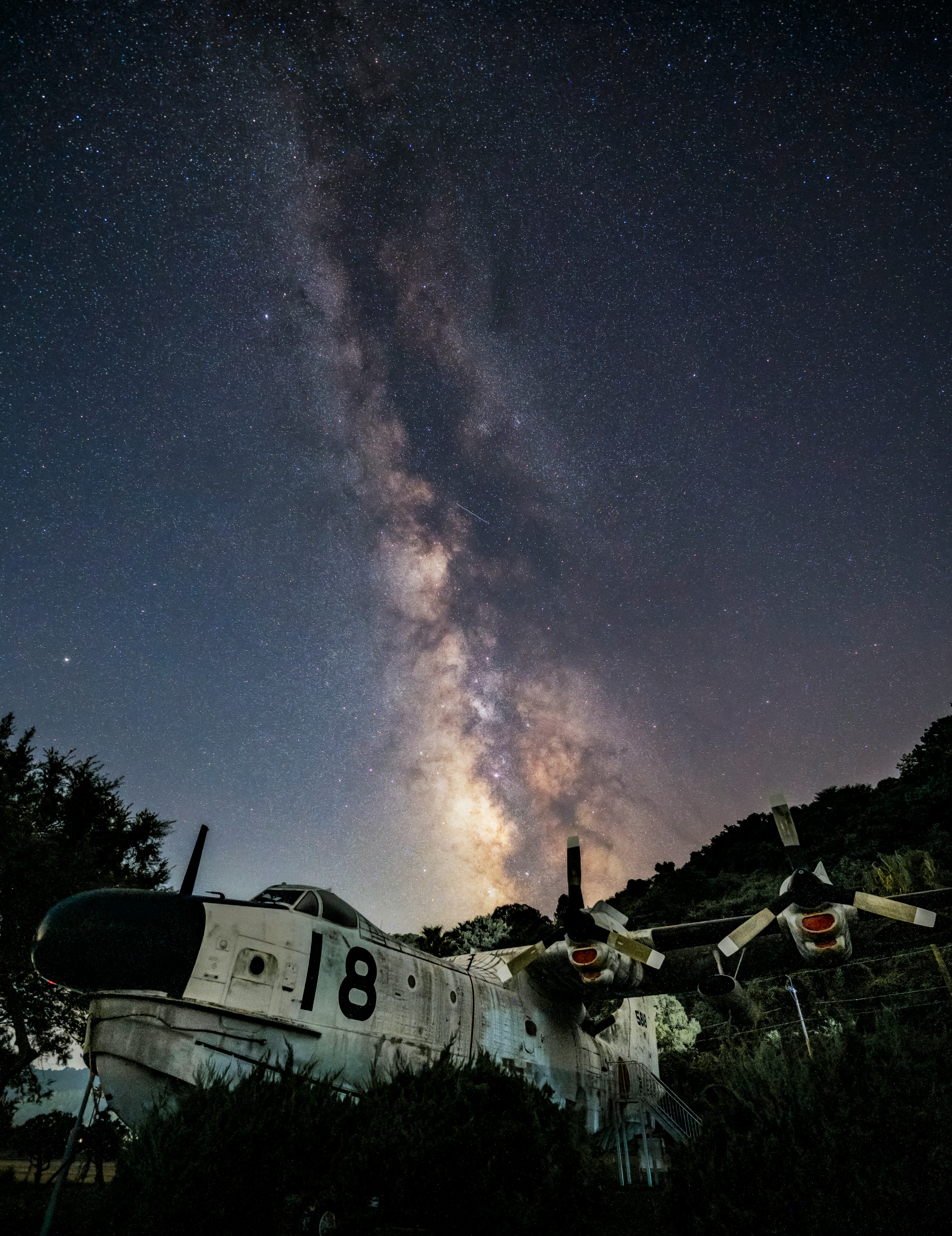 Milky Way galaxy over a vintage aircraft in an abandoned location