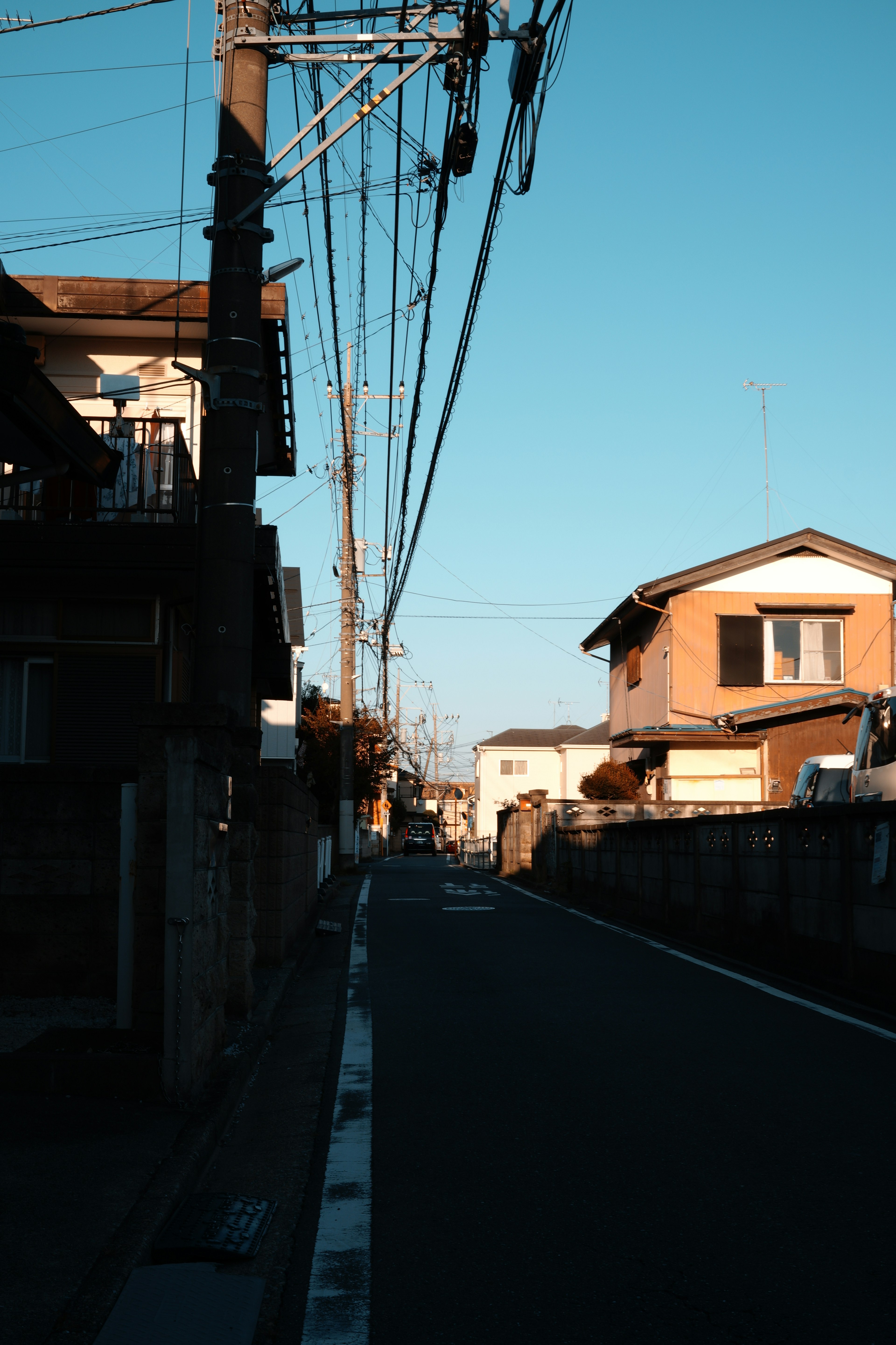 Ruhige Straße in einem japanischen Wohngebiet mit klarem blauen Himmel