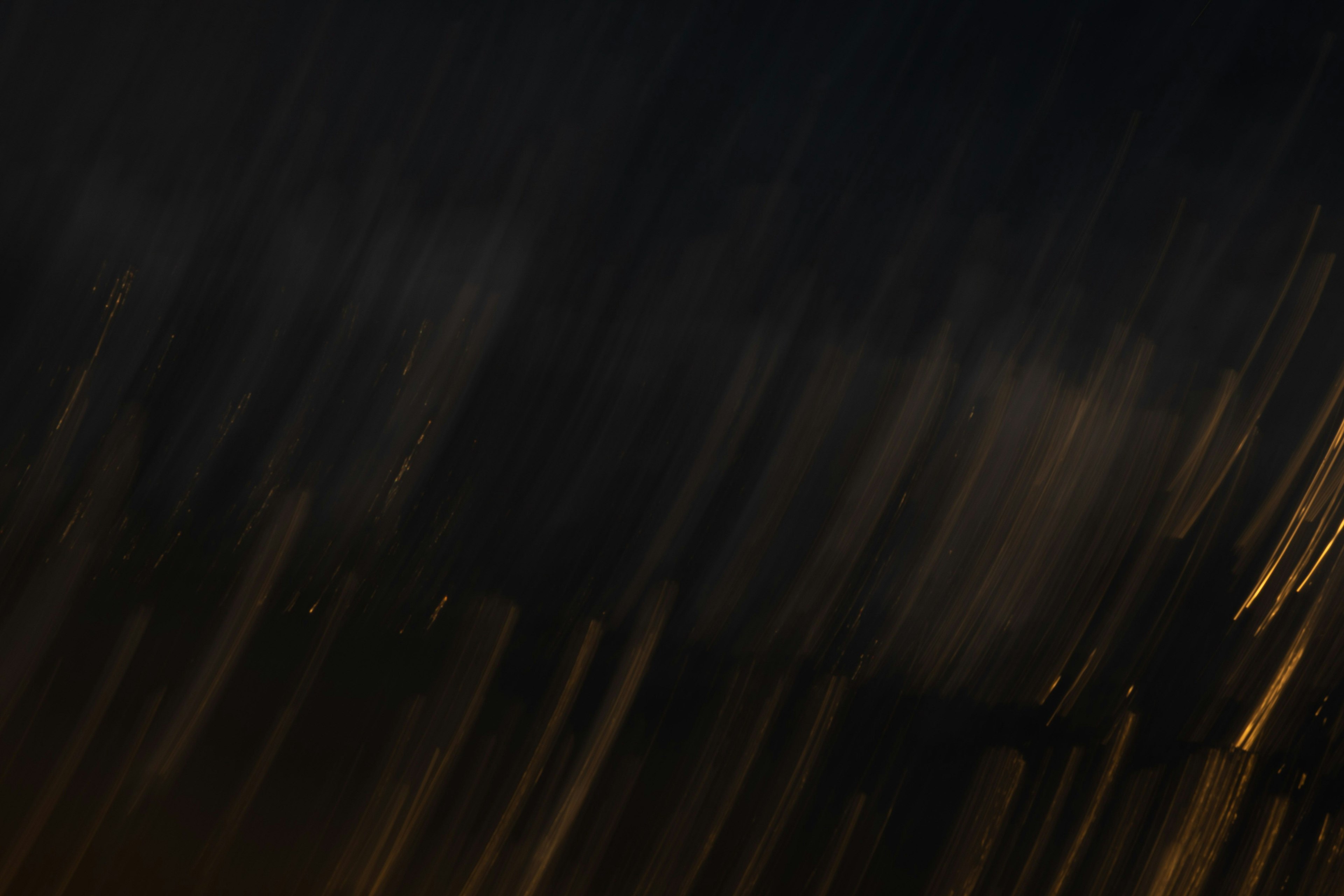 Abstract image featuring streaks of light against a dark background