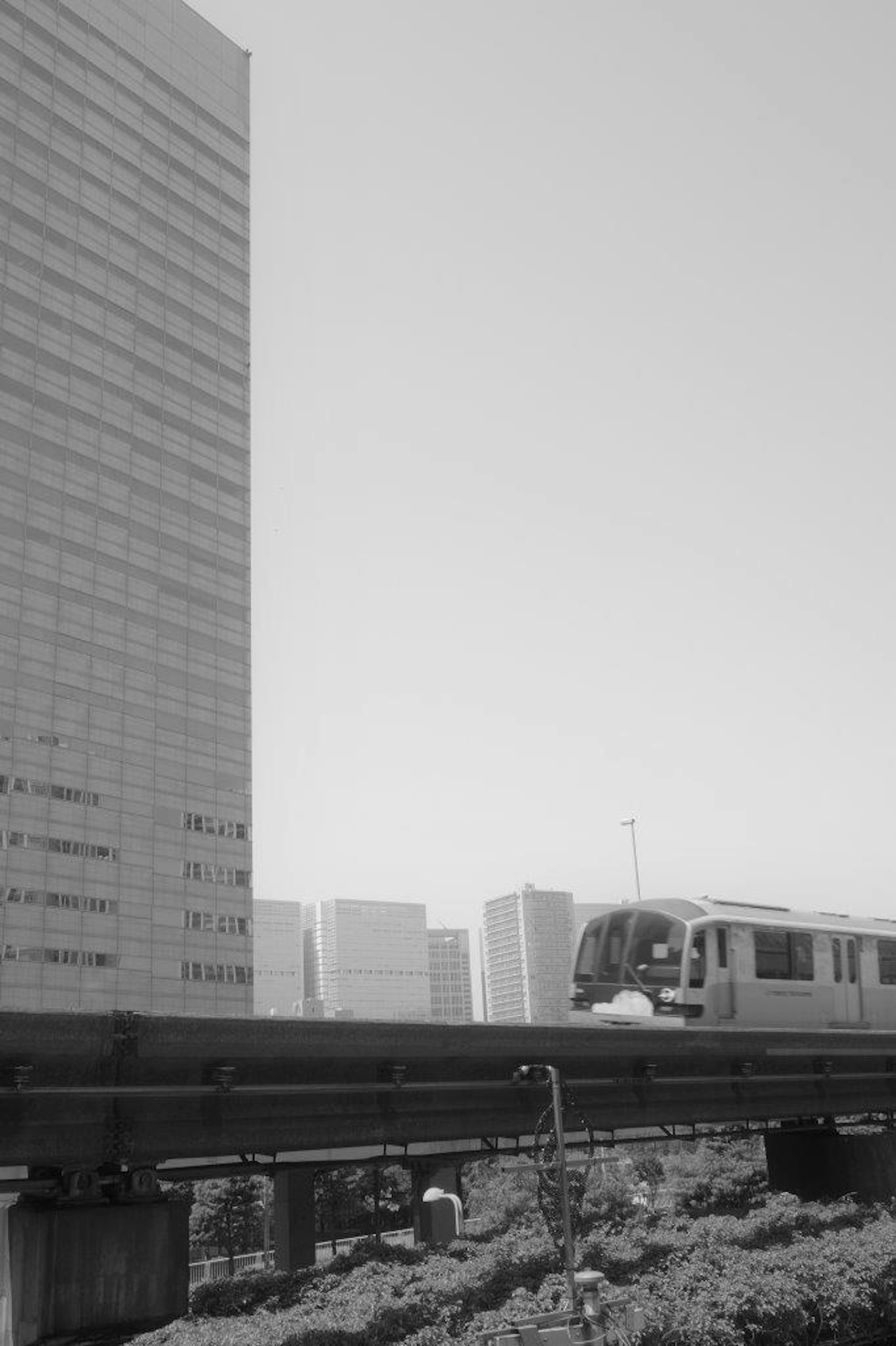 Urban landscape featuring a skyscraper and a monorail