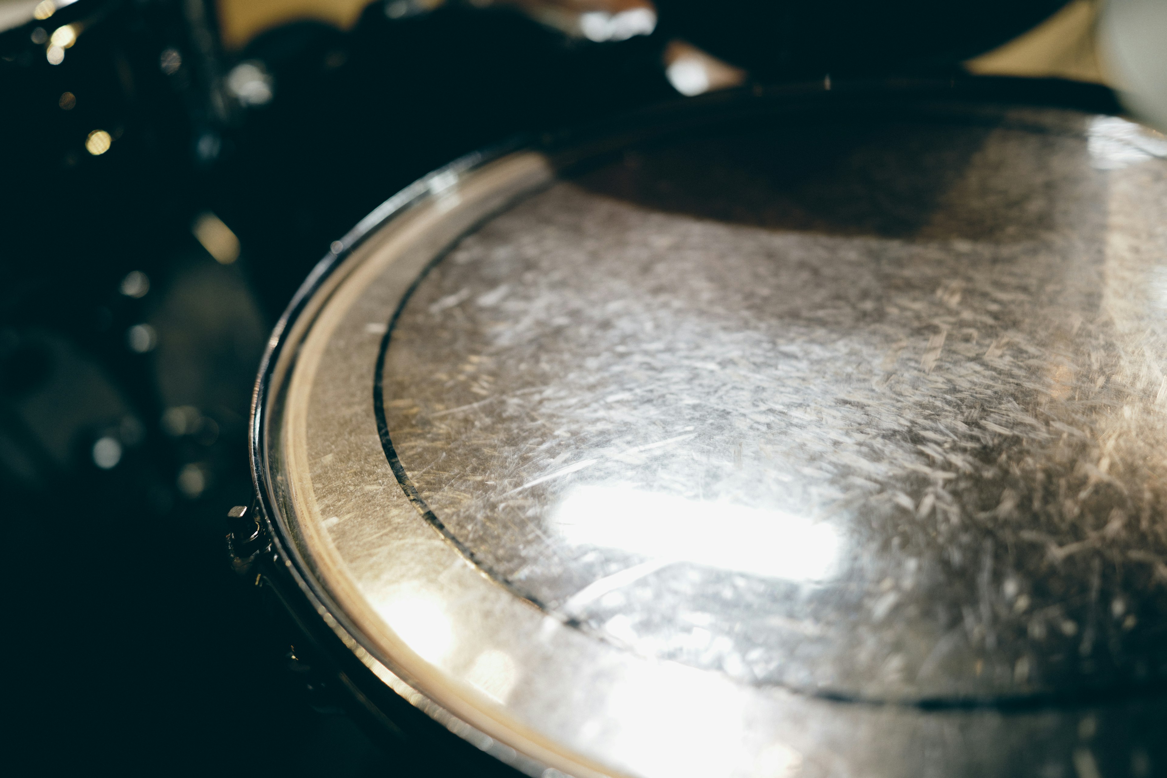 Shiny drum head with surrounding black drum elements