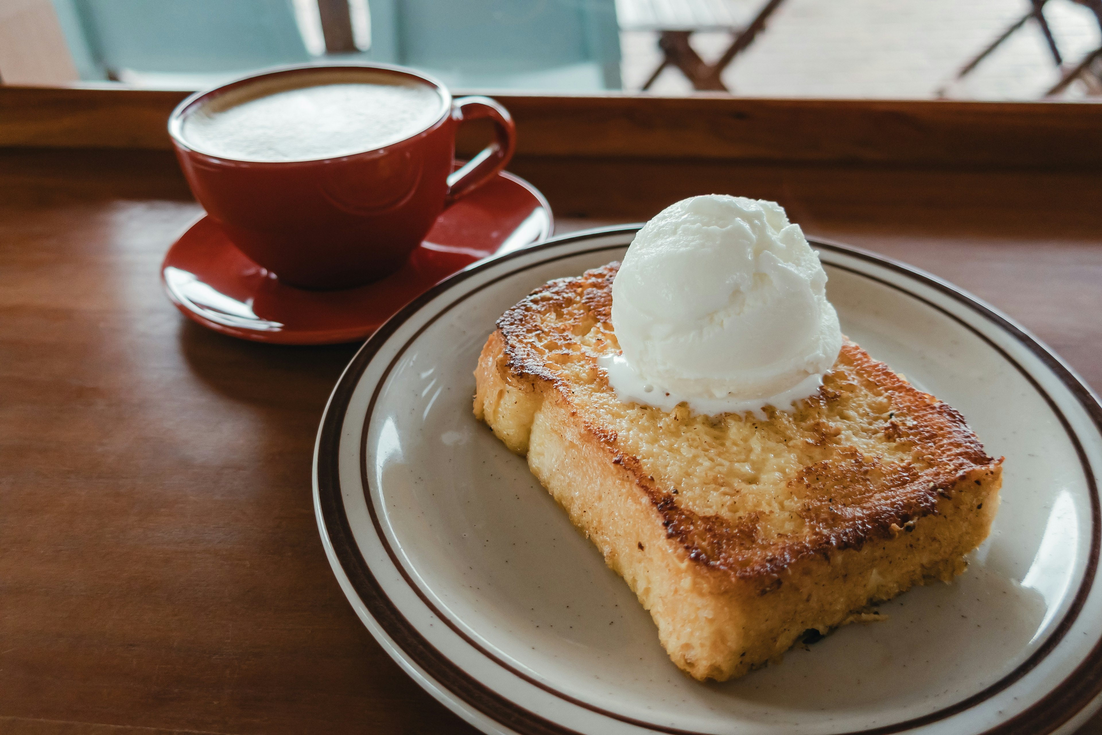 Dessert toast topped with ice cream served with a cup of coffee