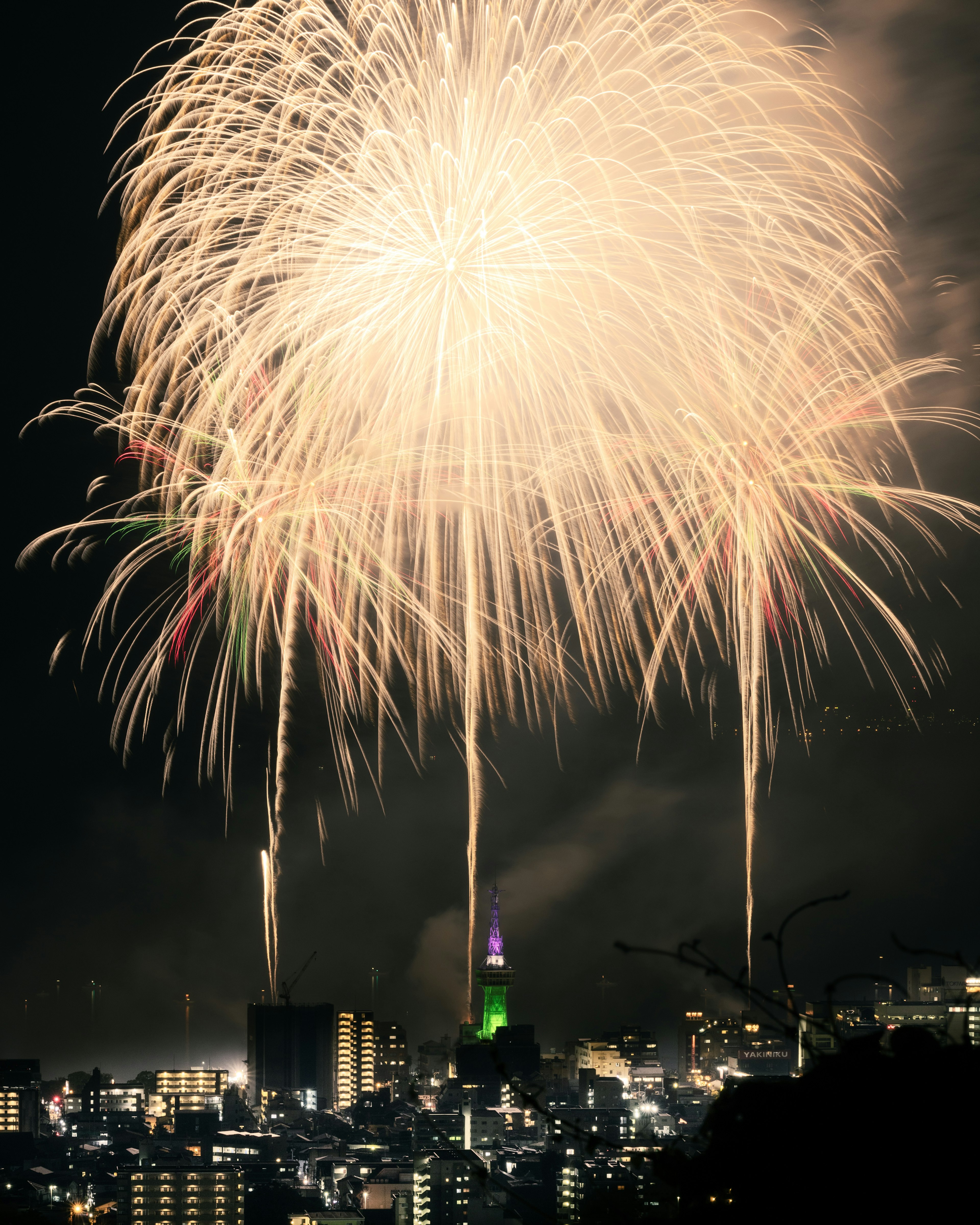 Fireworks over Tokyo skyline with illuminated buildings