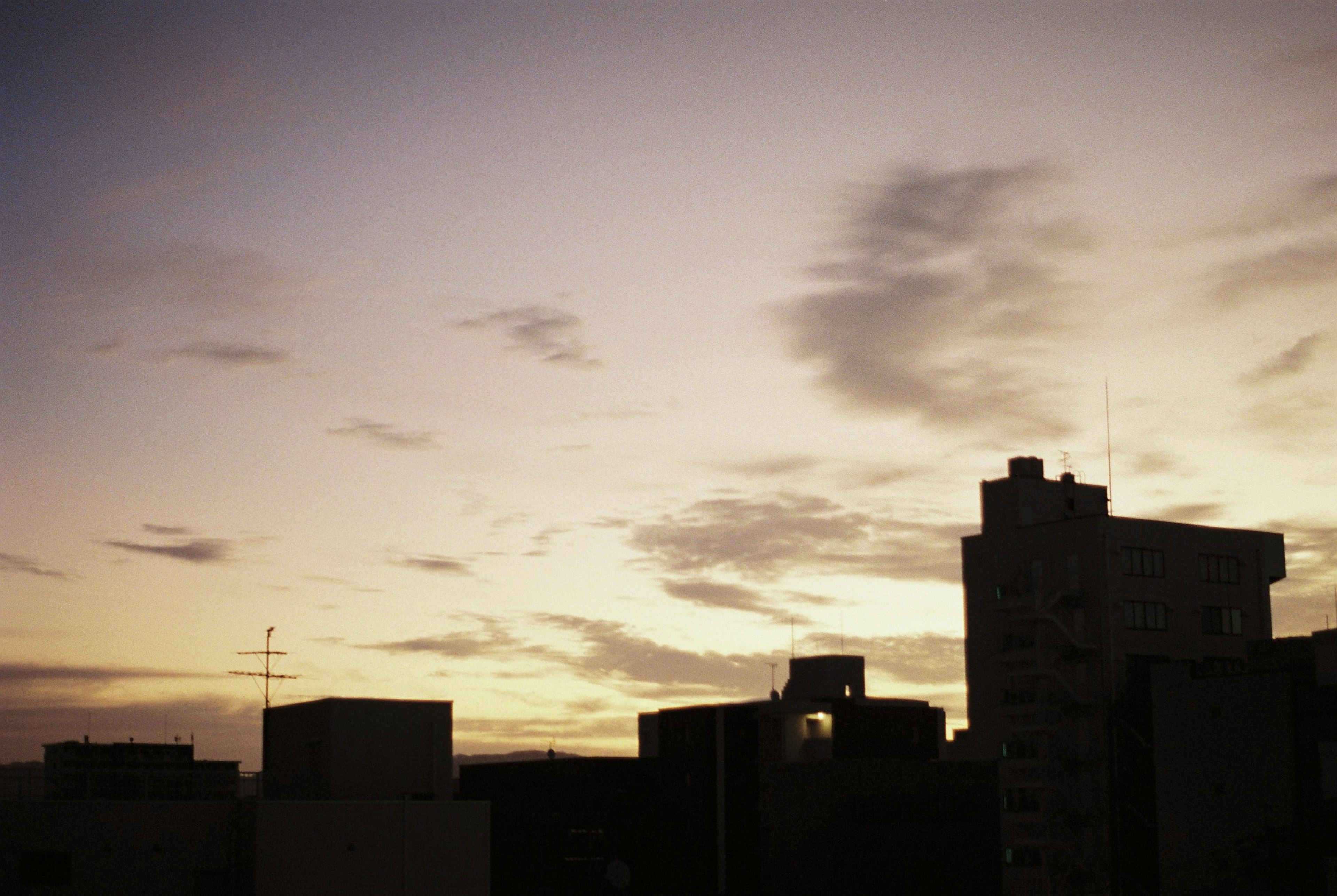 夕焼けの空とシルエットの建物が映る風景