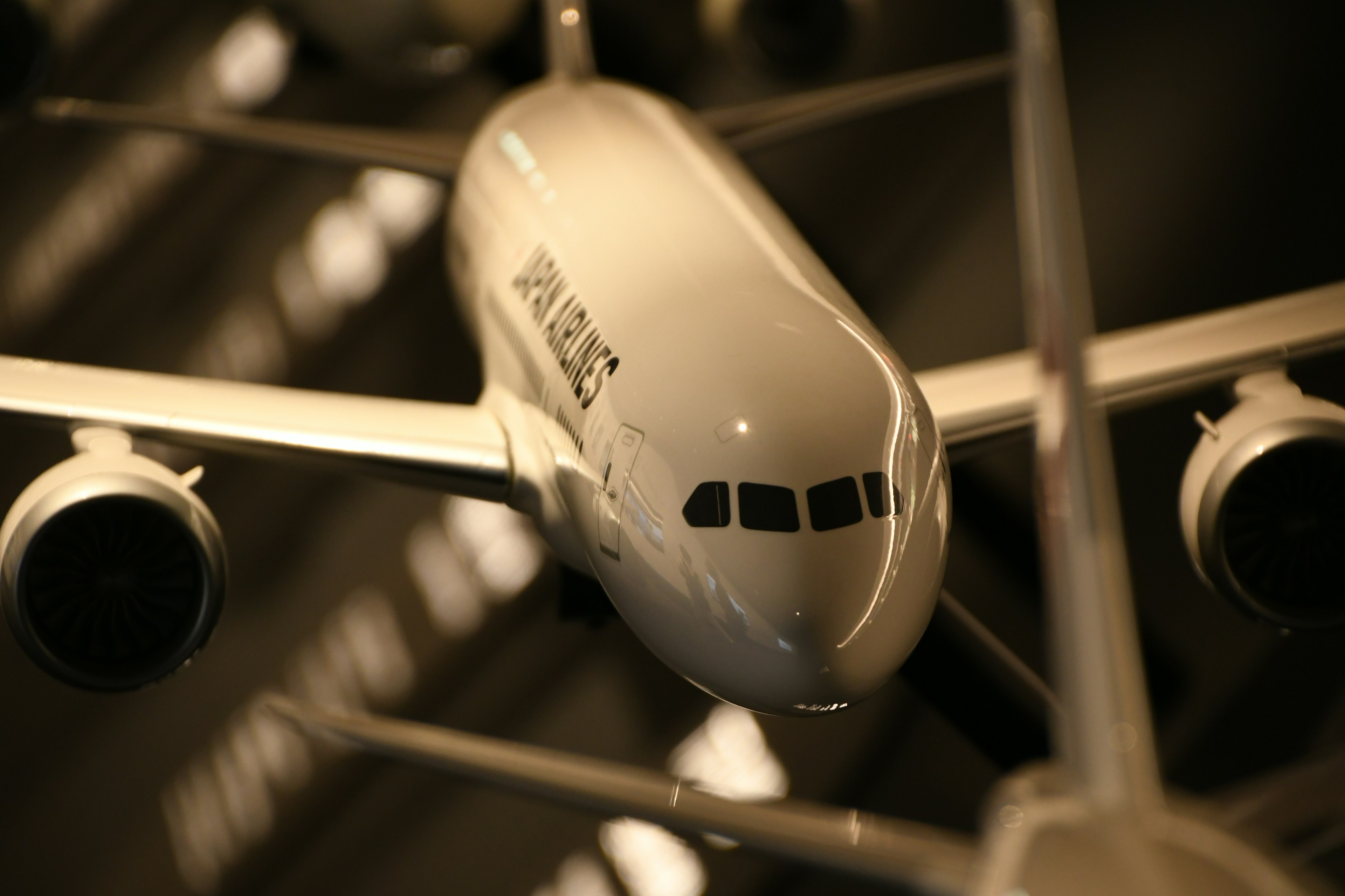 Close-up of a model airplane showcasing its details in bright lighting