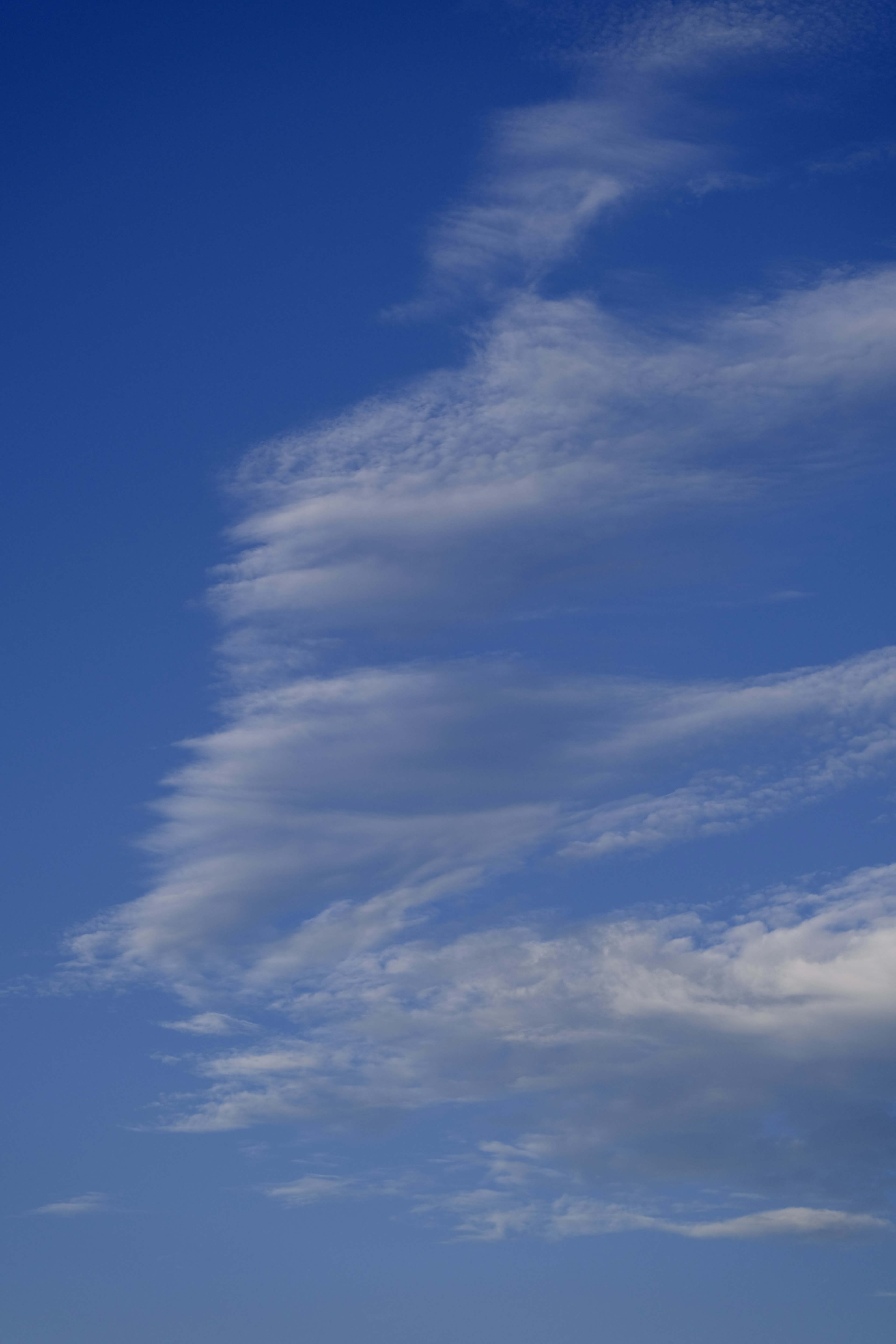 Unique cloud formations in a clear blue sky