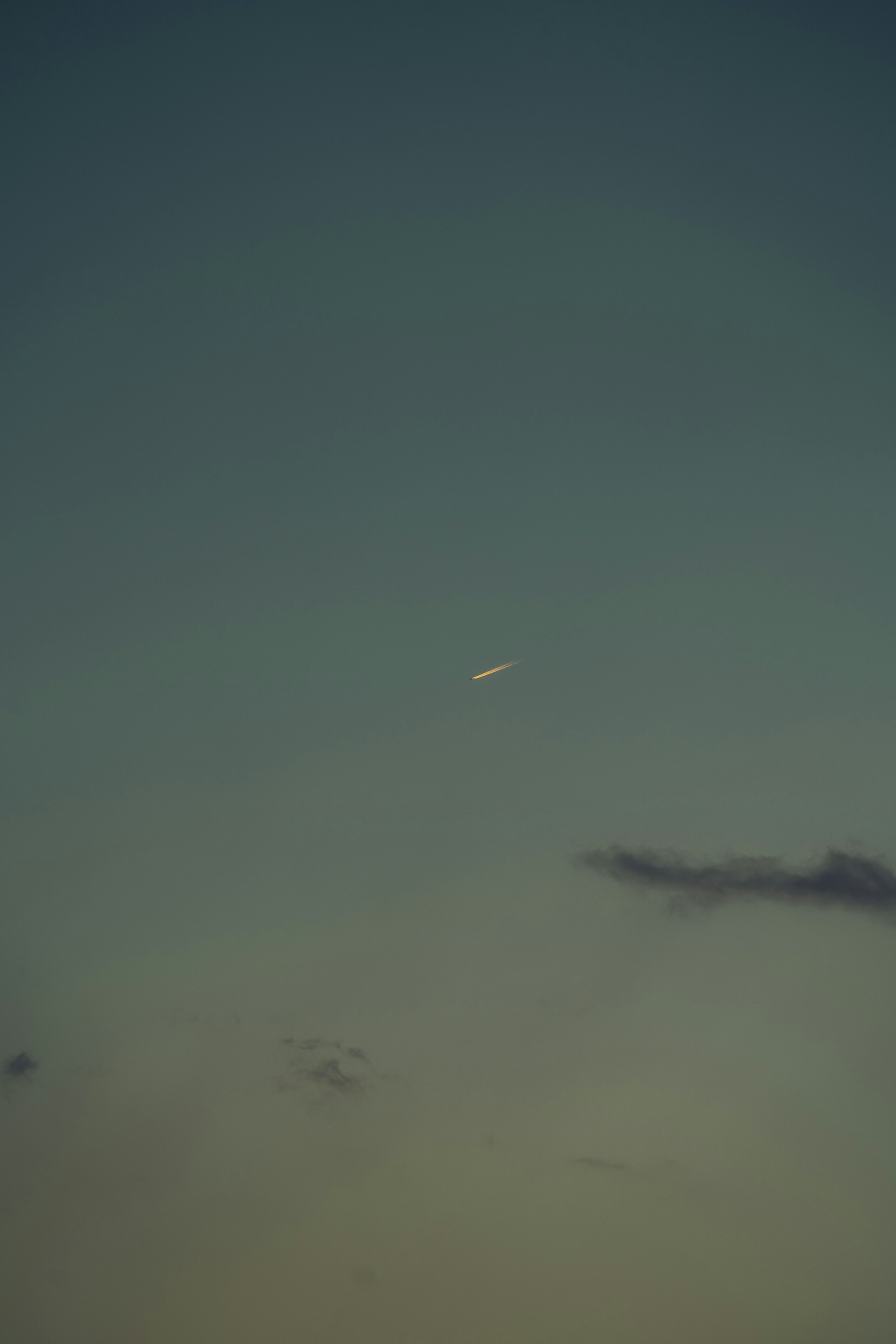 A white object in the blue sky with some clouds