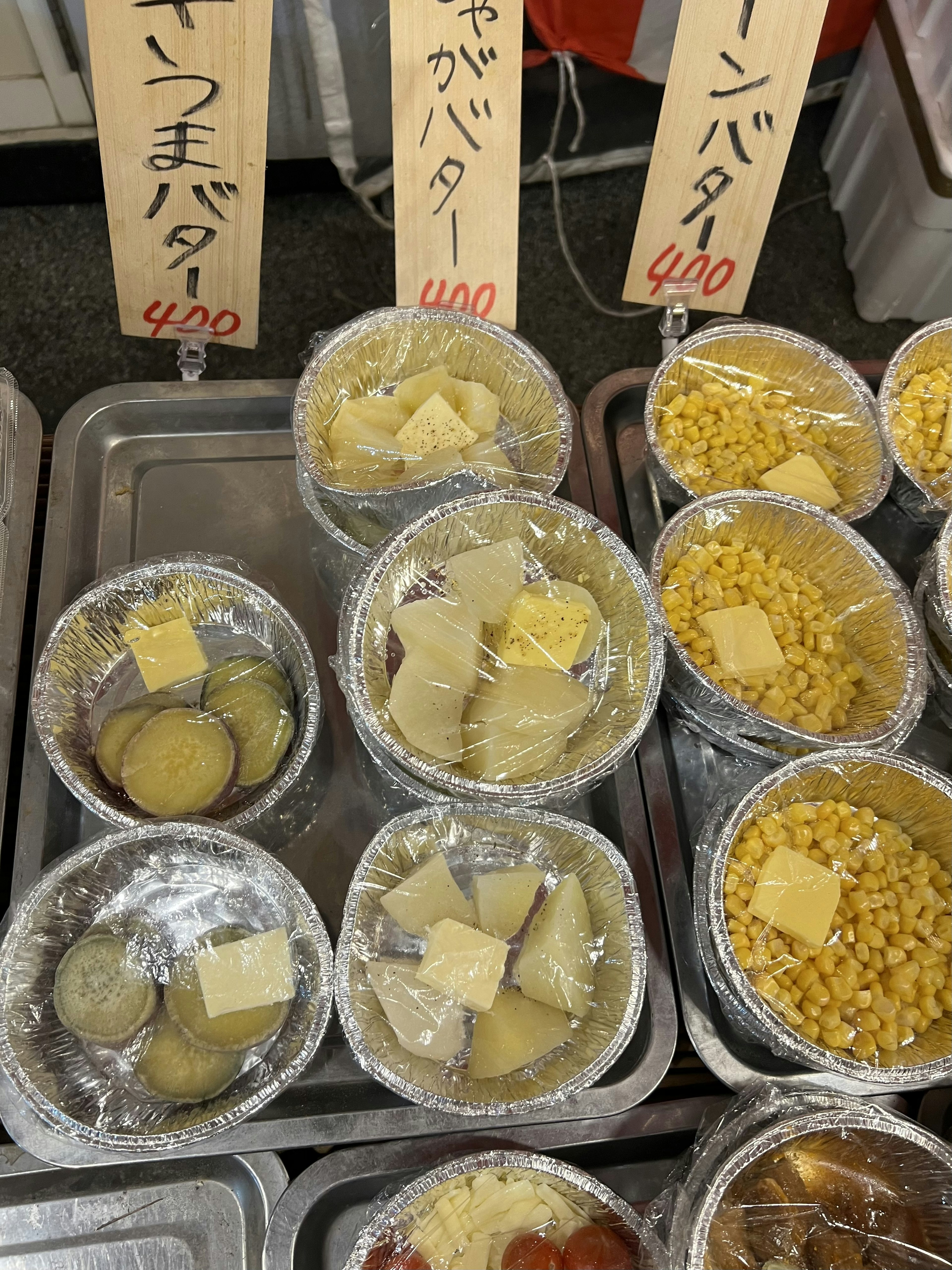 Various butter containers displayed at a market