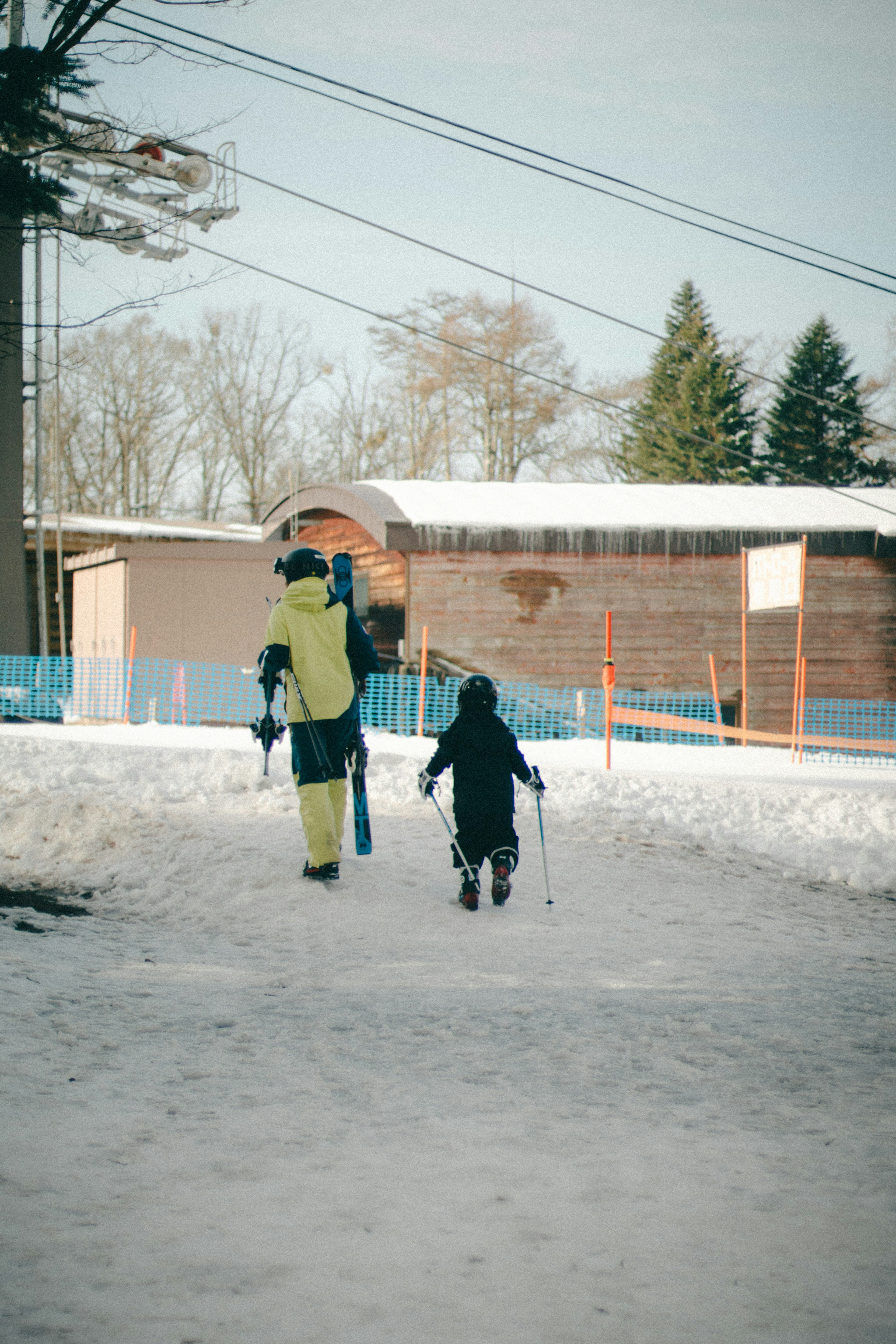 Adult and child walking in the snow