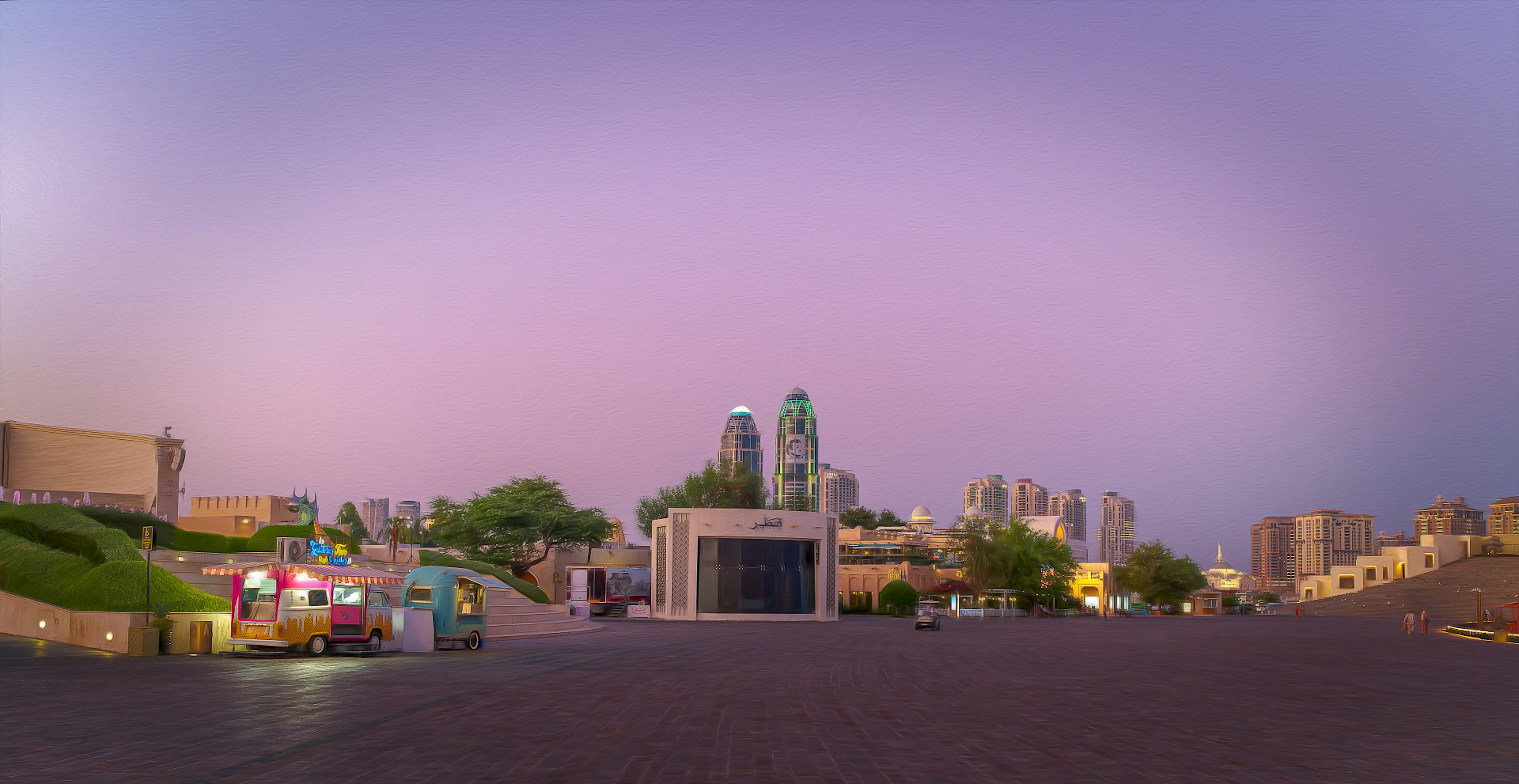 City square at dusk featuring buildings and green hills