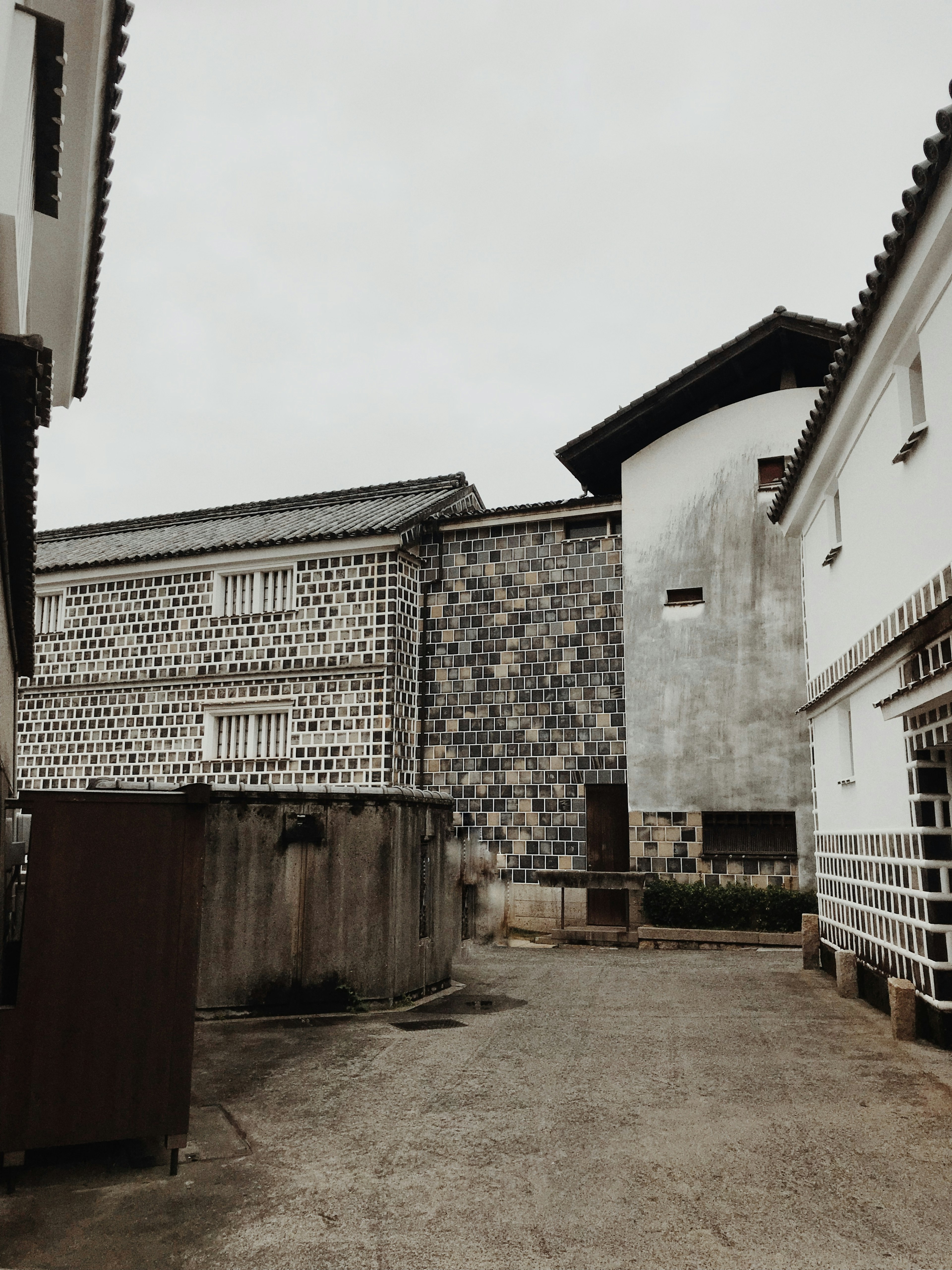 Unique architectural landscape under gray sky featuring vertical windows and modern building design