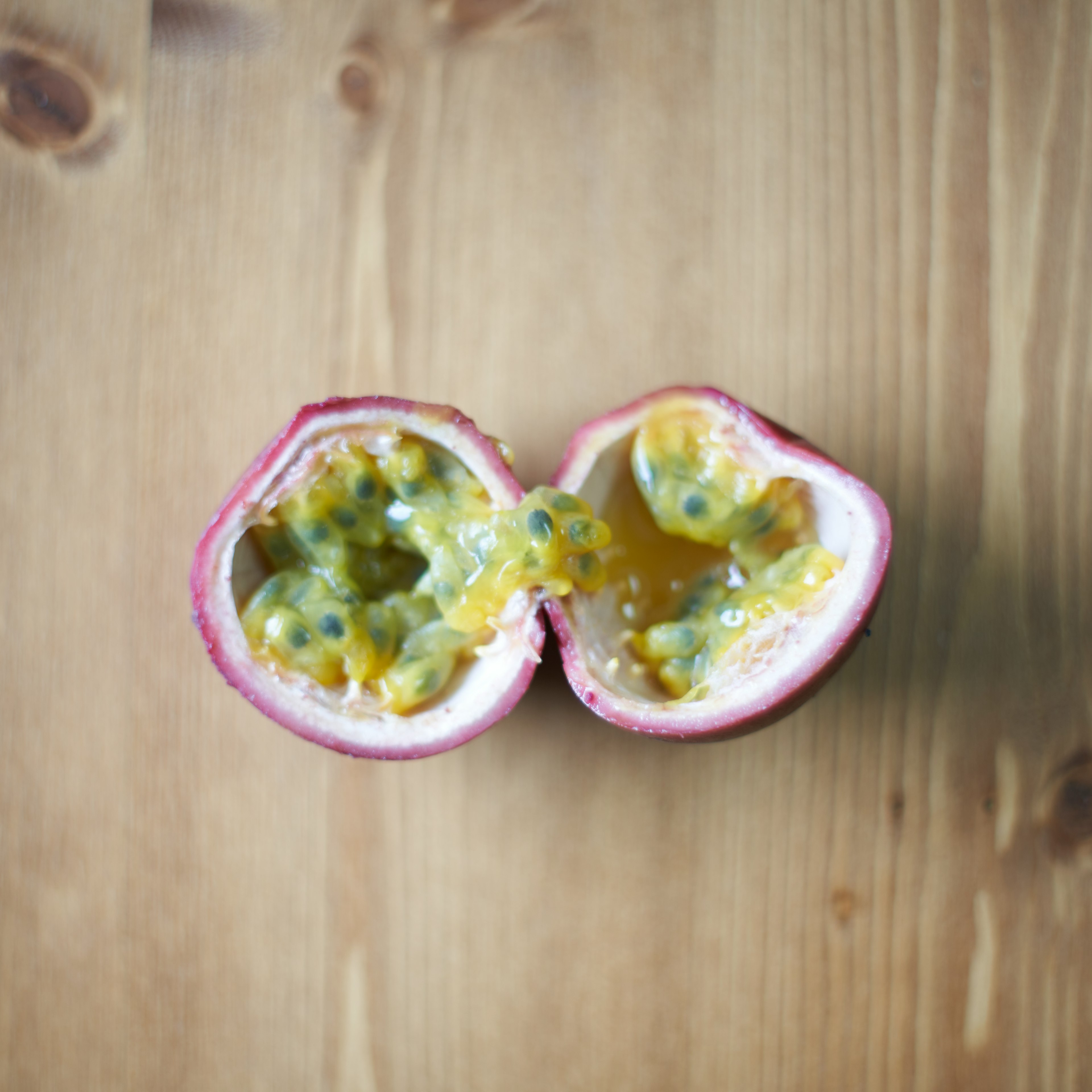 Halved passion fruit showcasing the vibrant yellow pulp and seeds